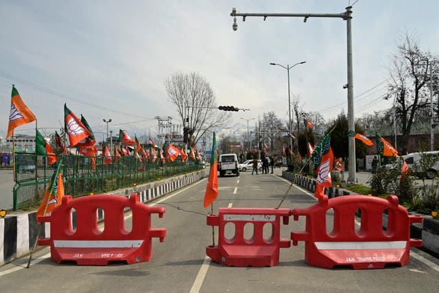 <p>Bhartiya Janta Party (BJP) flags are seen placed along a road blocked near the avenue where India's Prime Minister Narendra Modi is scheduled to address on March 7 a public rally in Srinagar</p>