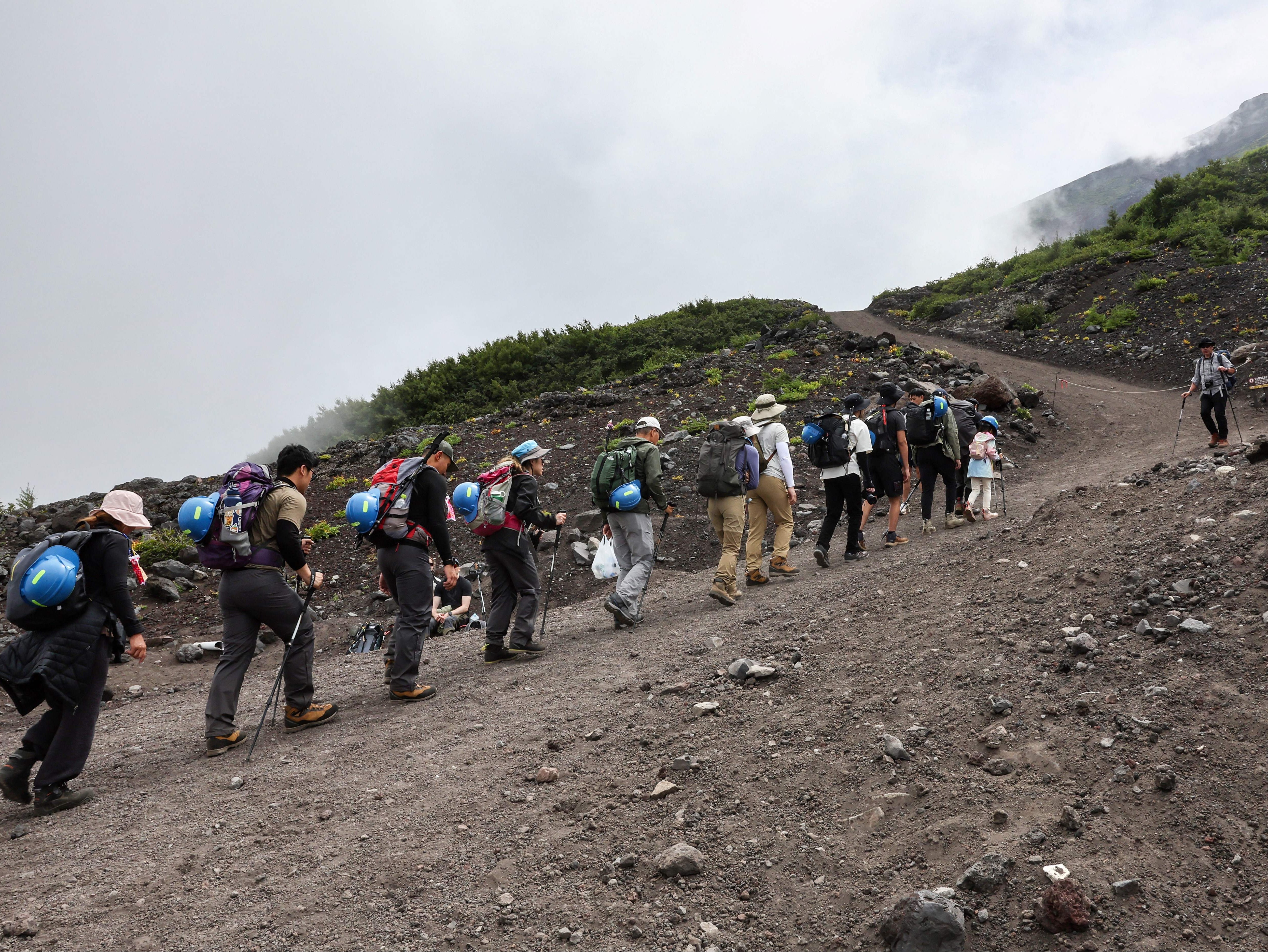 <p>This photo taken on 31 August 2023 shows visitors climbing the slopes of Mount Fuji, Japan’s highest peak at 3,776 metres (12,388 feet)</p>