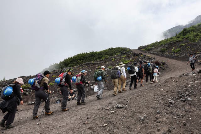<p>This photo taken on 31 August 2023 shows visitors climbing the slopes of Mount Fuji, Japan’s highest peak at 3,776 metres (12,388 feet)</p>