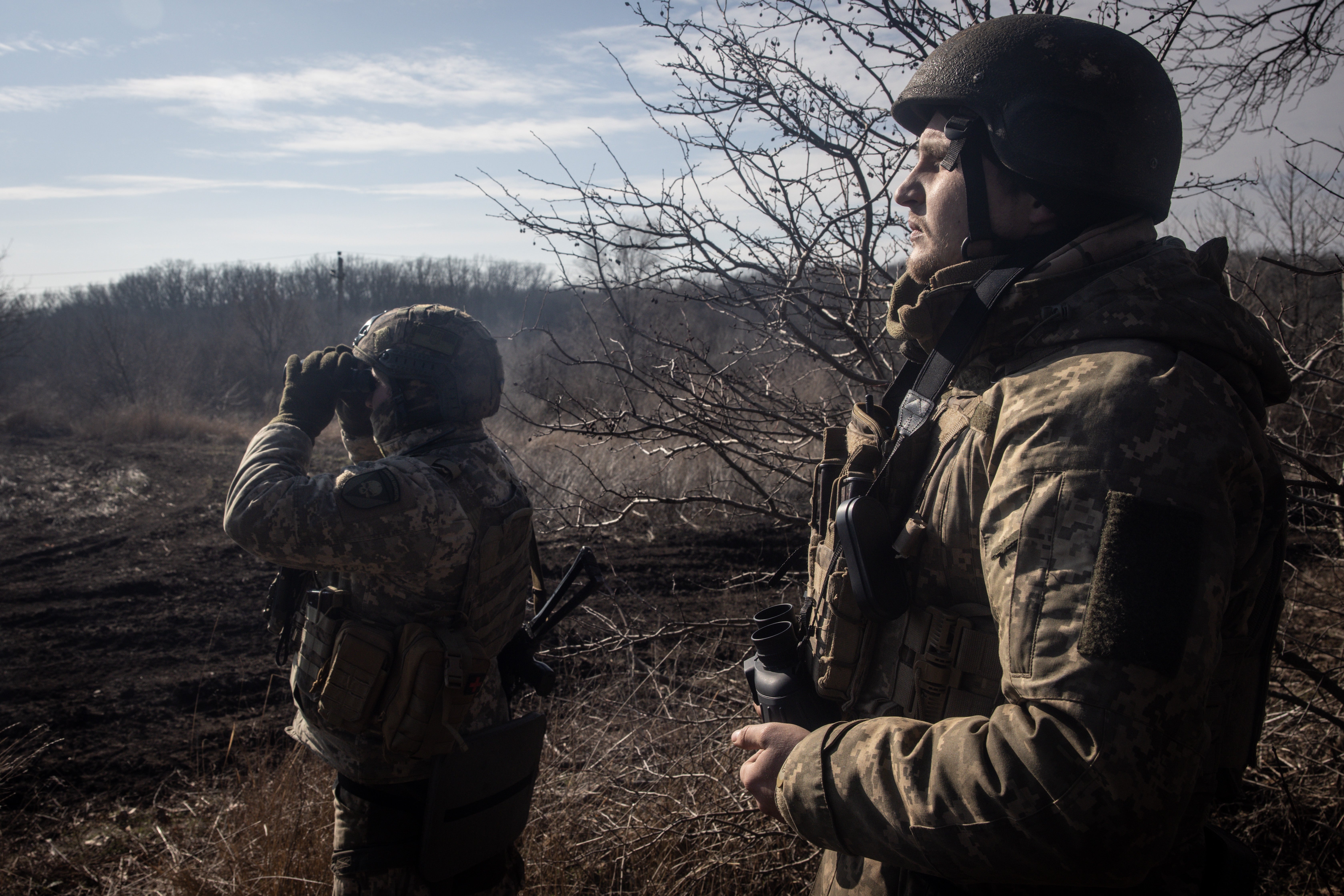 Members of Ukraine’s 72nd Brigade Anti-air unit use binoculars to search for Russian drones on 23 February 2024 near Marinka, Ukraine