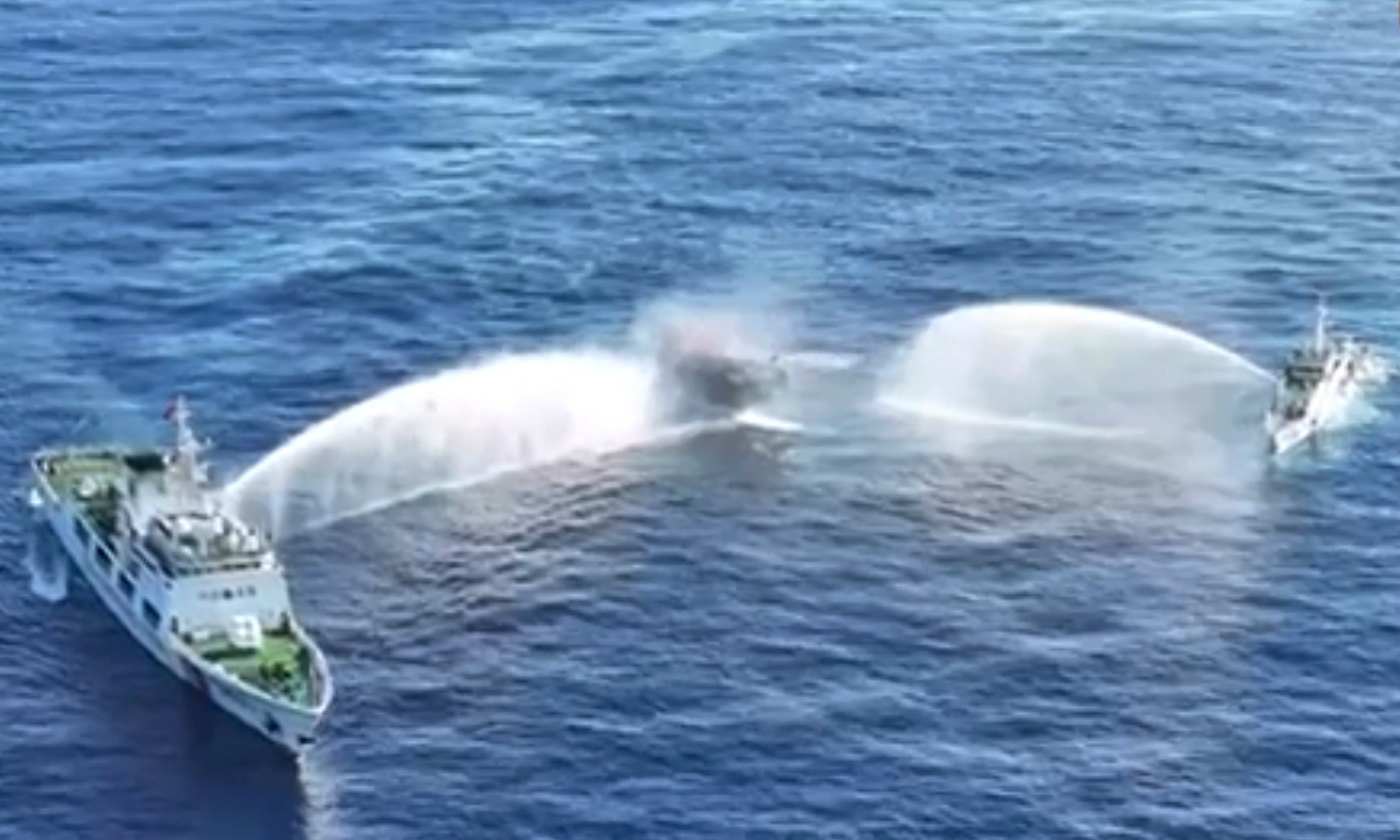 In this image made from video provided by the Philippine Coast Guard, Philippine resupply vessel Unaizah May 4, center, is hit by two Chinese coast guard water canon blasts, causing injuries to multiple crew members as they tried to enter the Second Thomas Shoal, locally known as Ayungin Shoal, in the disputed South China Sea, Tuesday, 5 March 2024