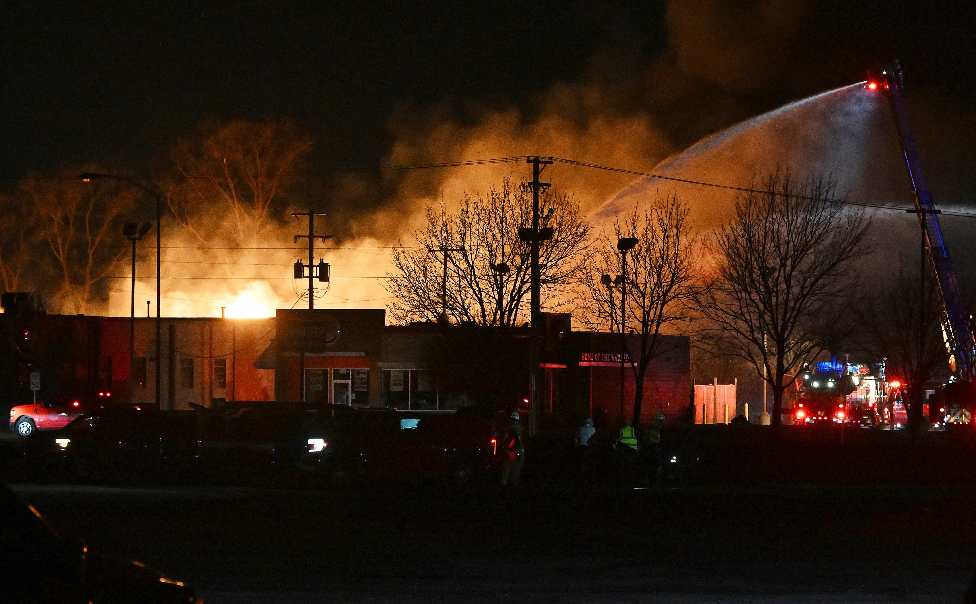 Fire departments fight an industrial fire near 15 Mile Road and Groesbeck Highway in Clinton Township