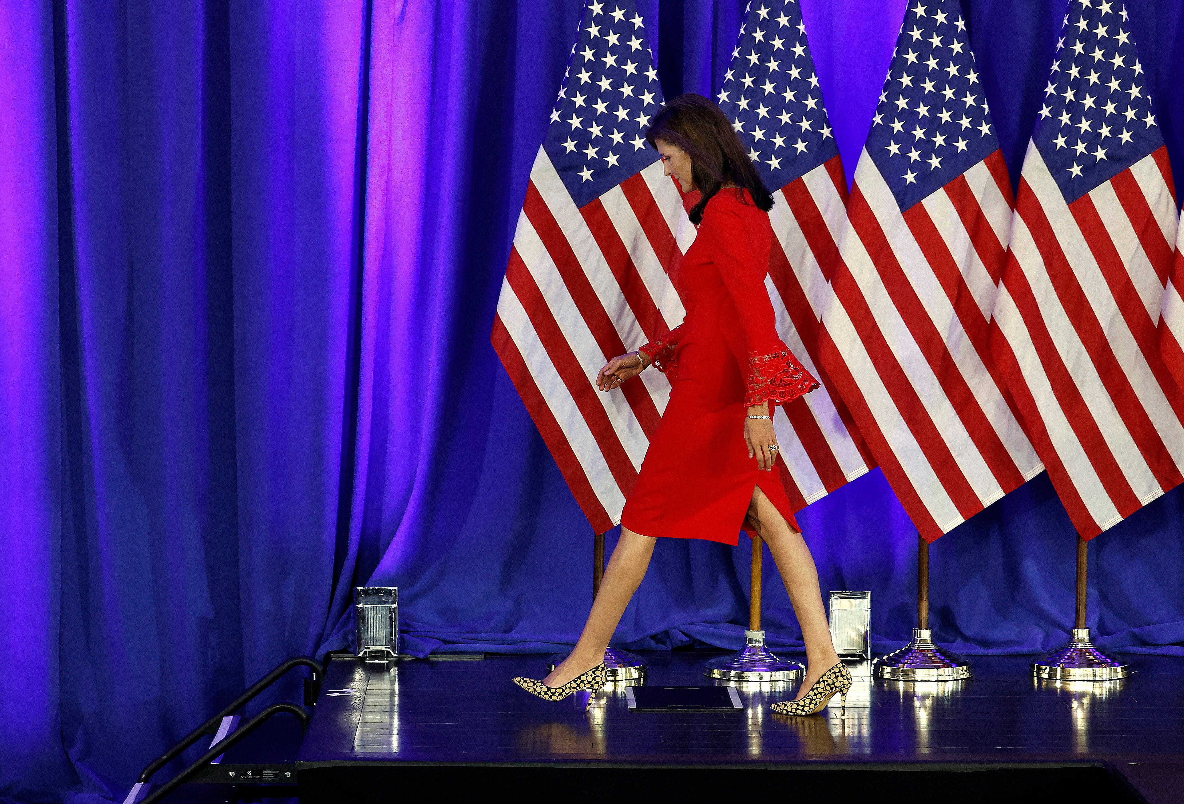 Nikki Haley walks off stage after announcing the suspension of her presidential campaign