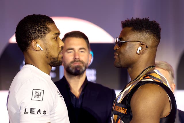 <p>Anthony Joshua (left) faces off with Francis Ngannou ahead of Friday’s fight</p>