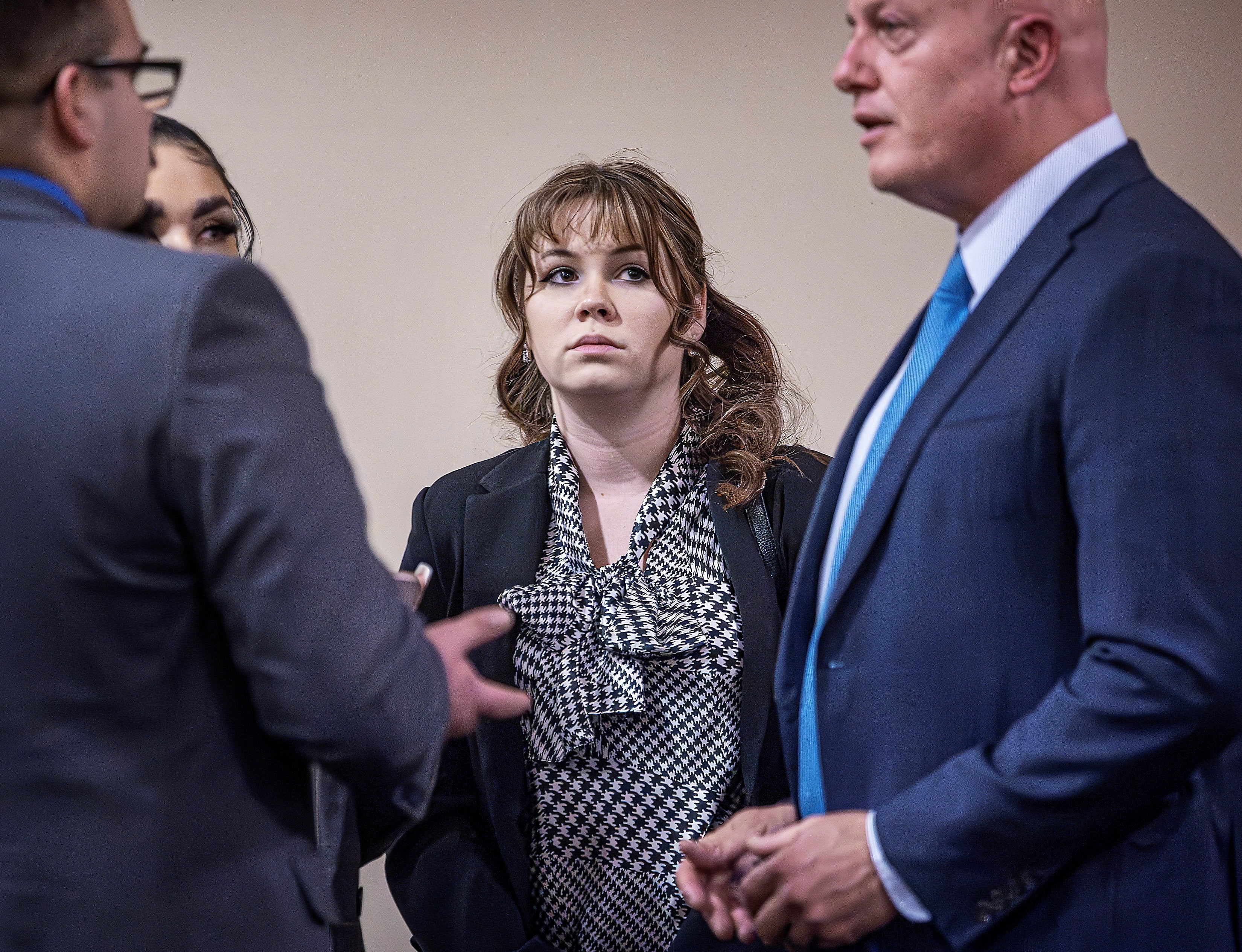 Hannah Gutierrez-Reed (center) talks with her attorney Jason Bowles (right) and her defense team during the trial against her in First District Court, in Santa Fe, N.M. on Friday, March, 1, 2024