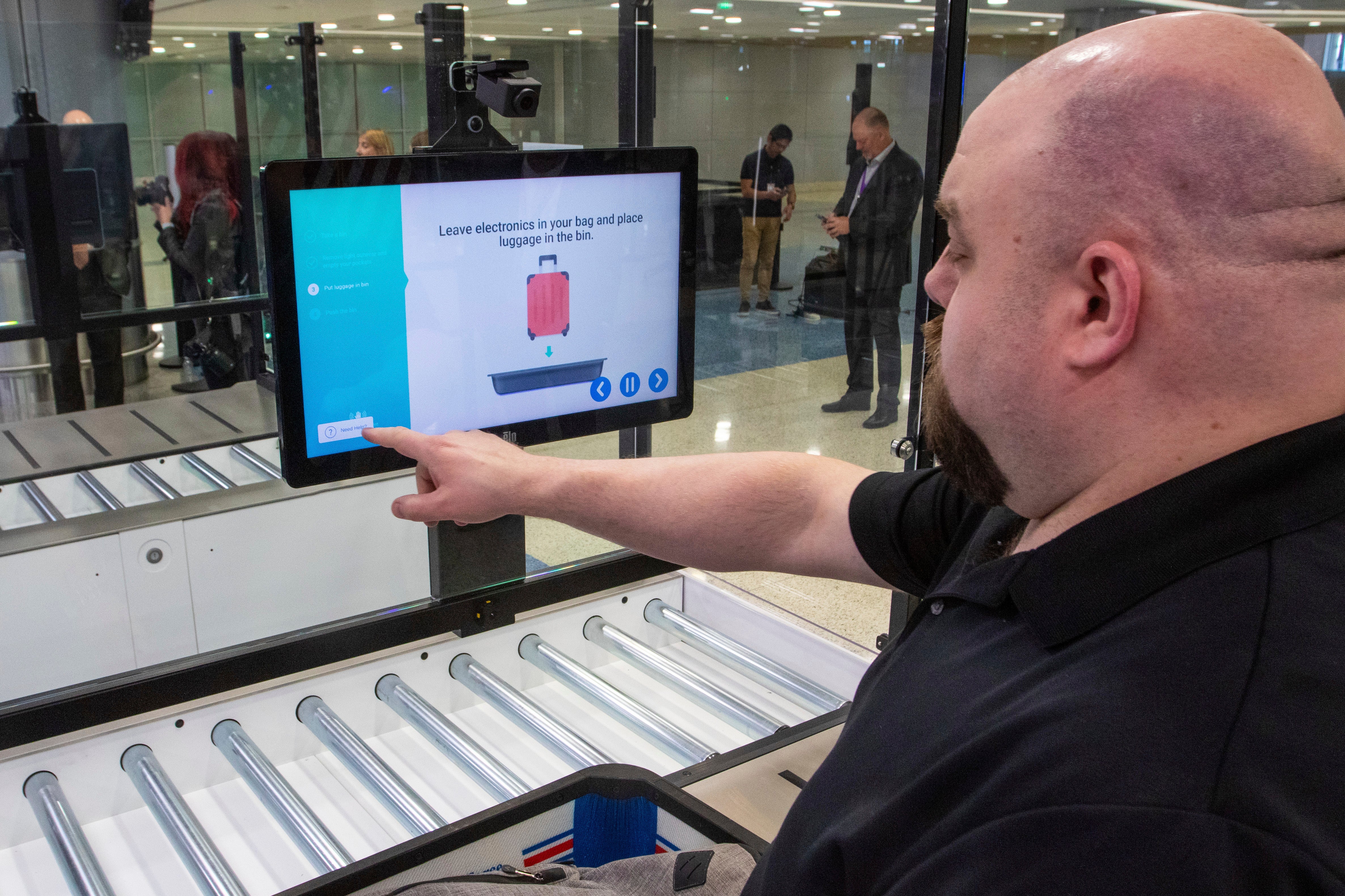 A TSA official demonstrates new screening equipment at Harry Reid International Airport