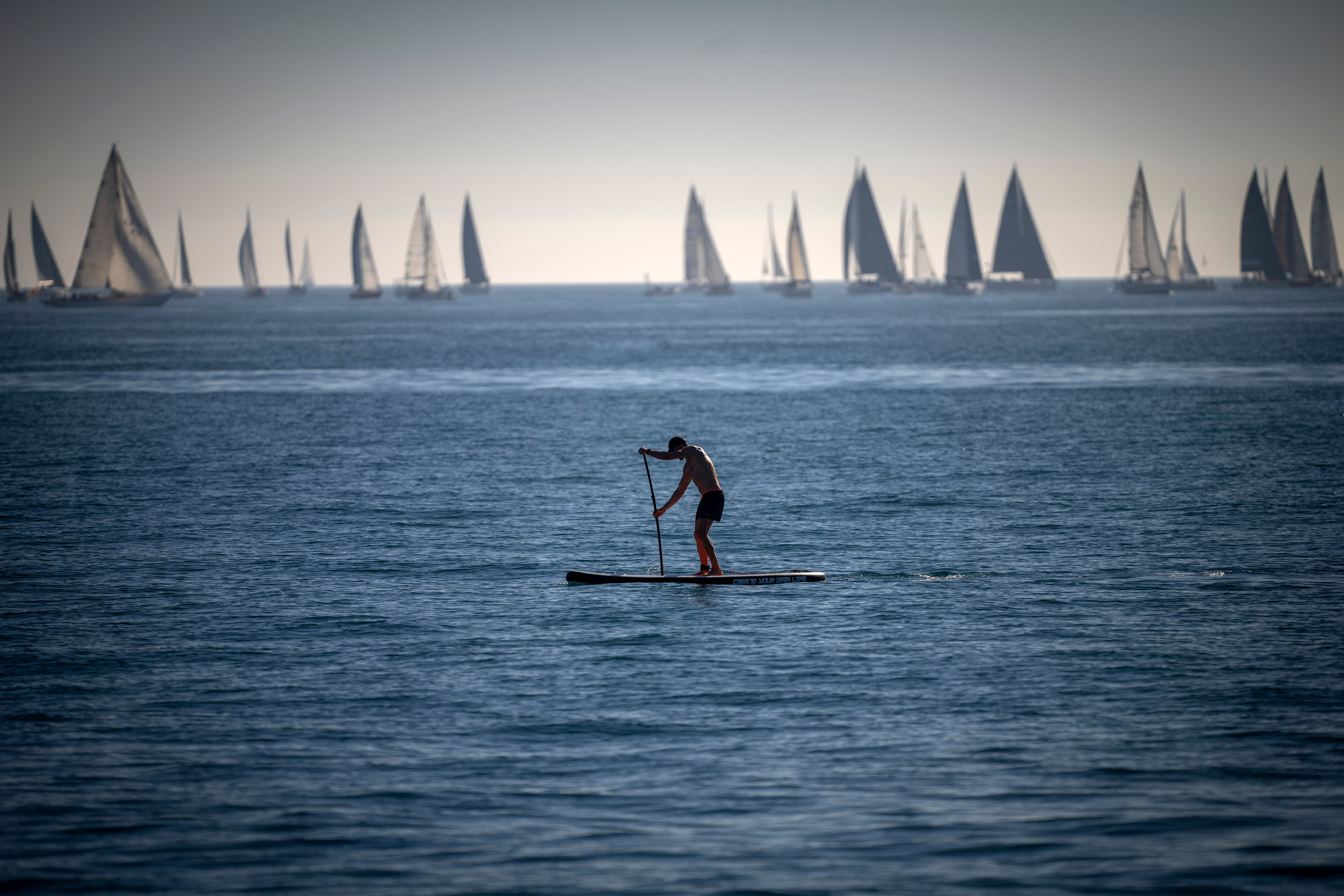 A man paddles in the Mediterranean Sea in Barcelona, Spain, in Febuary