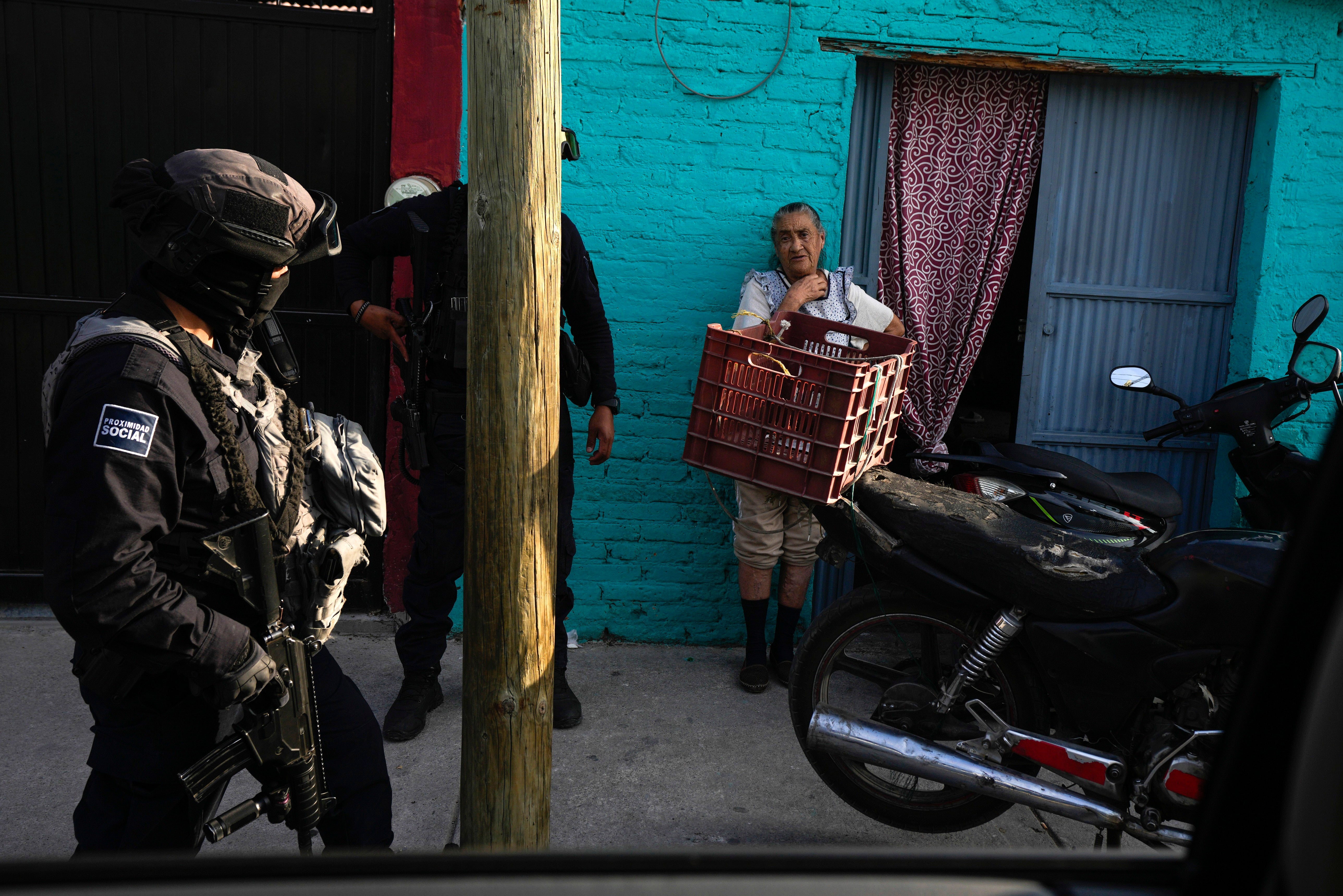 Mexico Police Municipal police officers chat with a resident while on patrol in her neighborhood in Celaya, Mexico