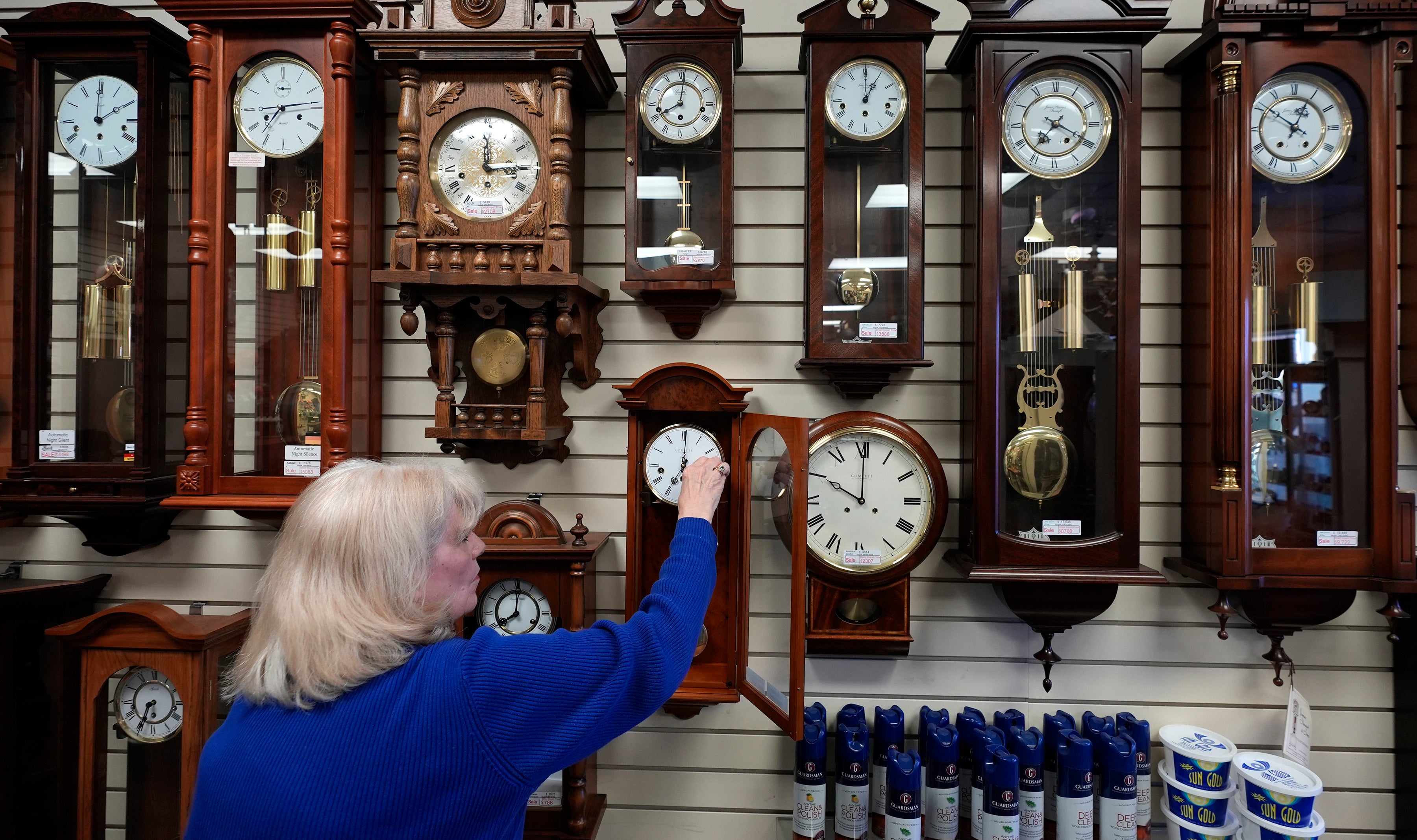 Glenda Marchesoni, owner of Heritage House Clocks, winds a clock at her shop Tuesday, March 5, 2024