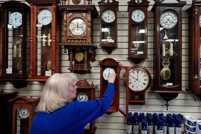 <p>Glenda Marchesoni, owner of Heritage House Clocks, winds a clock at her shop Tuesday, March 5, 2024</p>