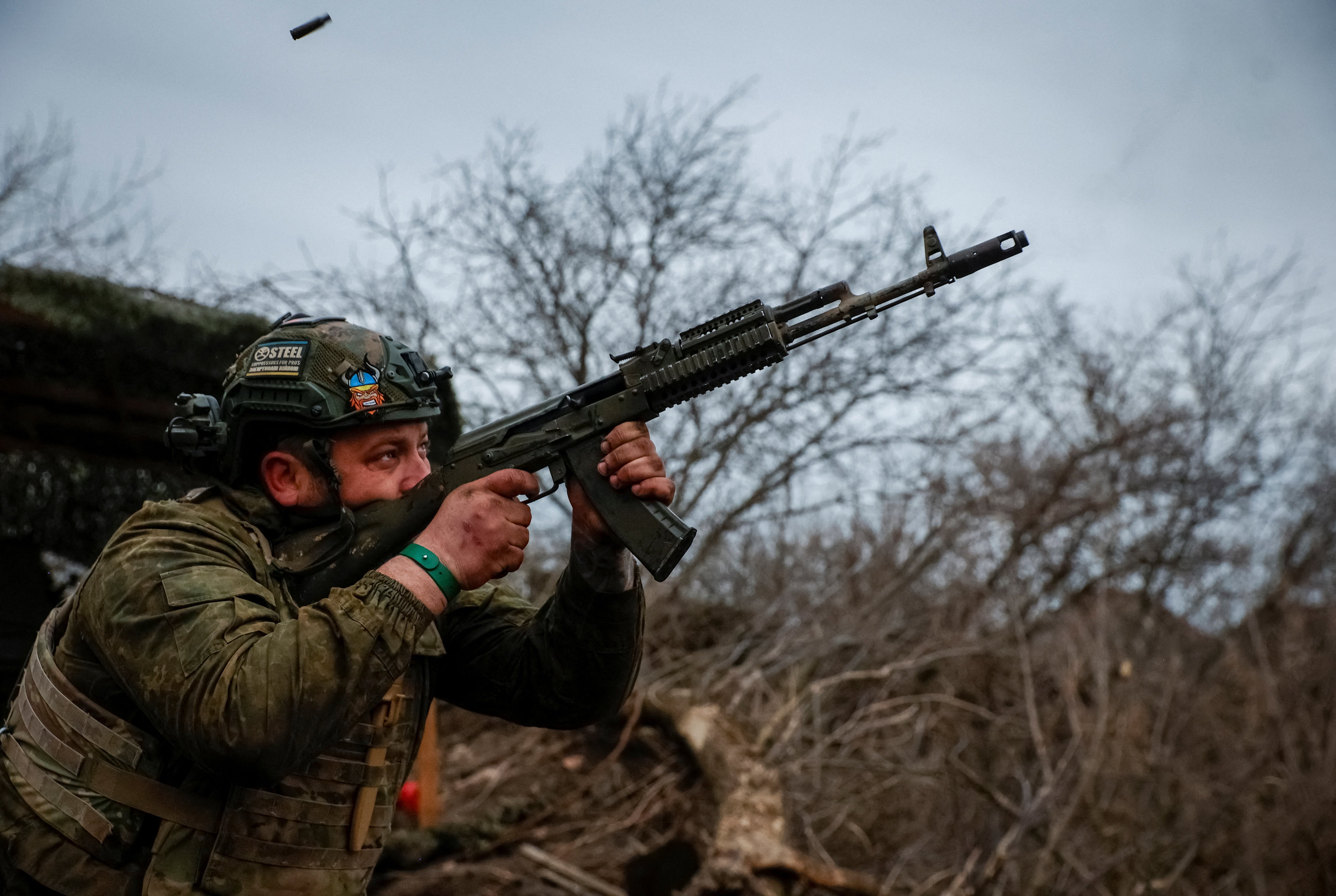 A Ukrainian serviceman from air defence unit of the 93rd Mechanized Brigade fires a AK-74 assault rifle on the eastern frontline near Bakhmut