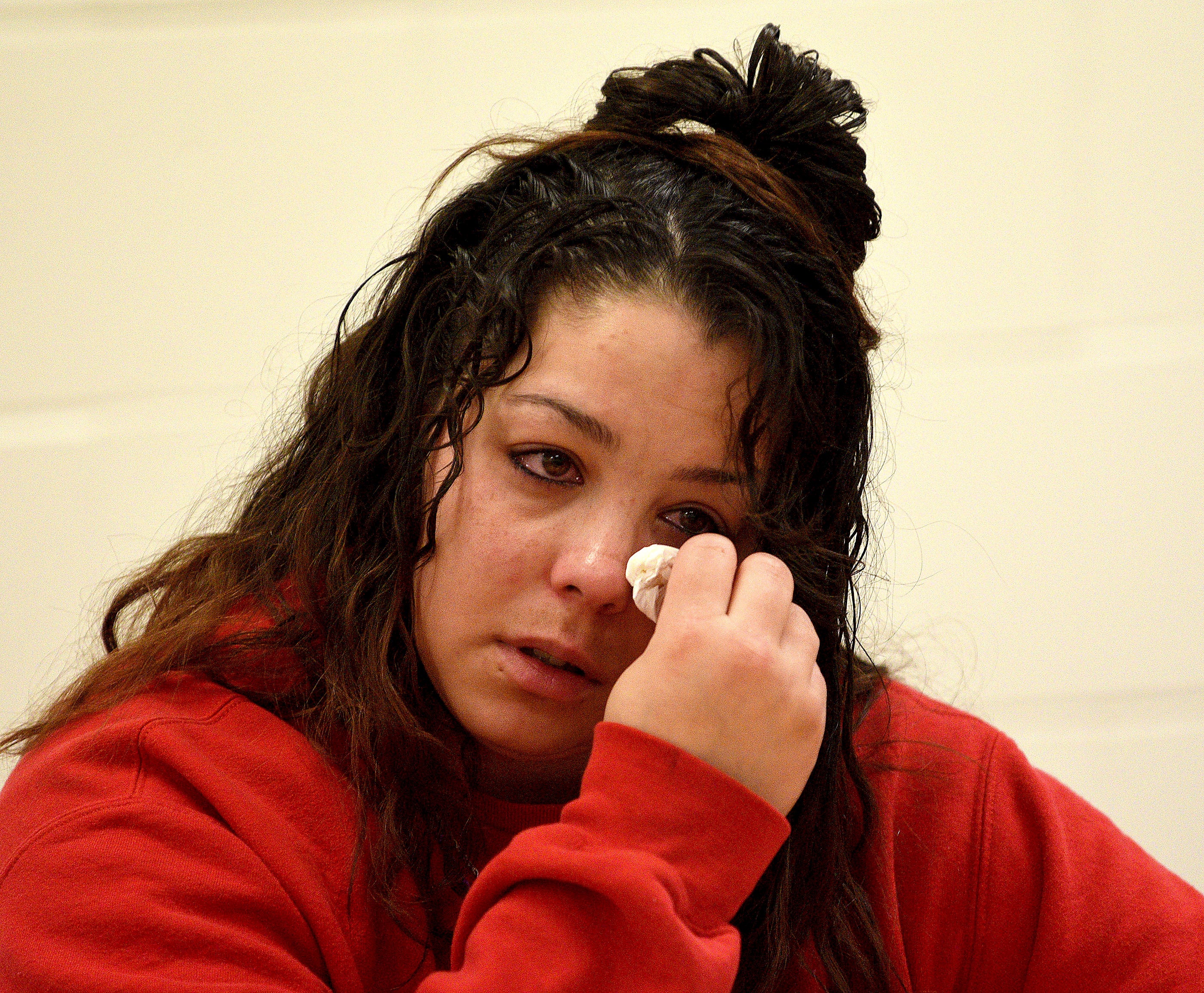 Kayla Montgomery wipes away tears during questioning from the parole board on March 7