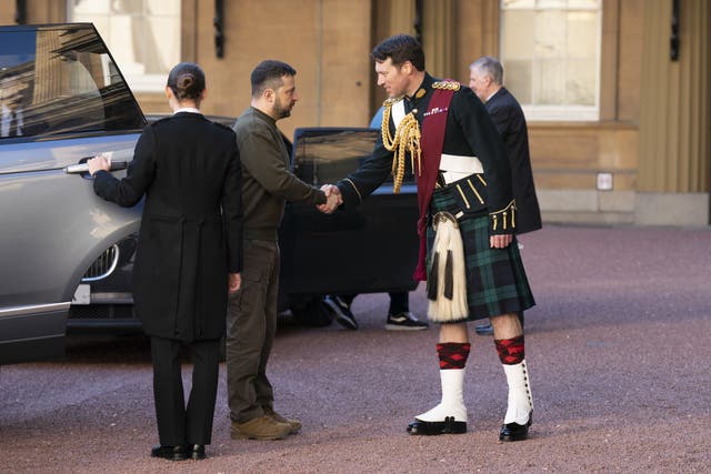 Ukrainian President Volodymyr Zelensky is greeted by Lieutenant Colonel Johnny Thompson, equerry to King Charles III, as he arrives for an audience with the King at Buckingham Palace (Kirsty O’Connor/PA)