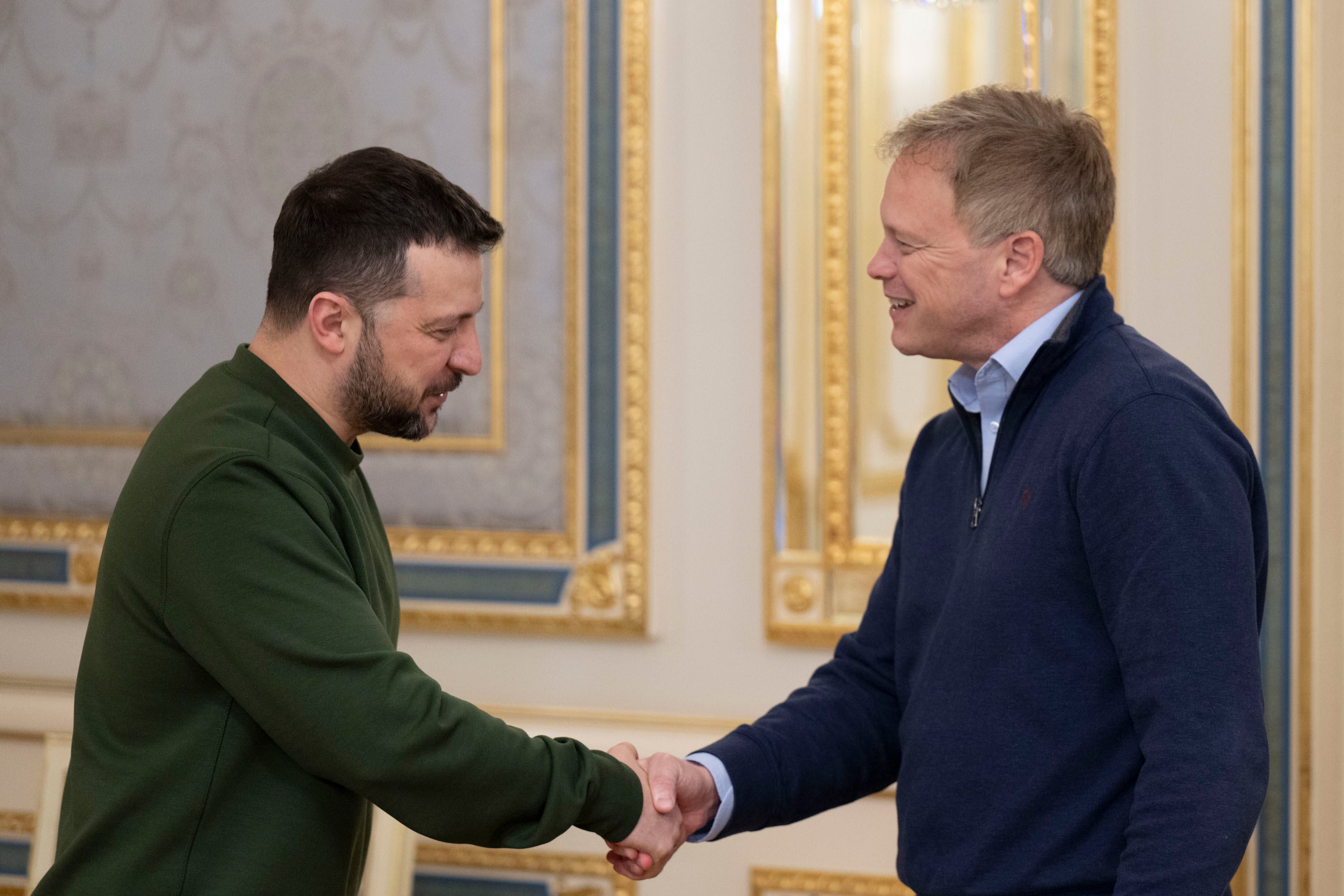 President Volodymyr Zelenskyy, left, and Britain's Defence Secretary Grant Shapps shake hands during their meeting in Kyiv, Ukraine