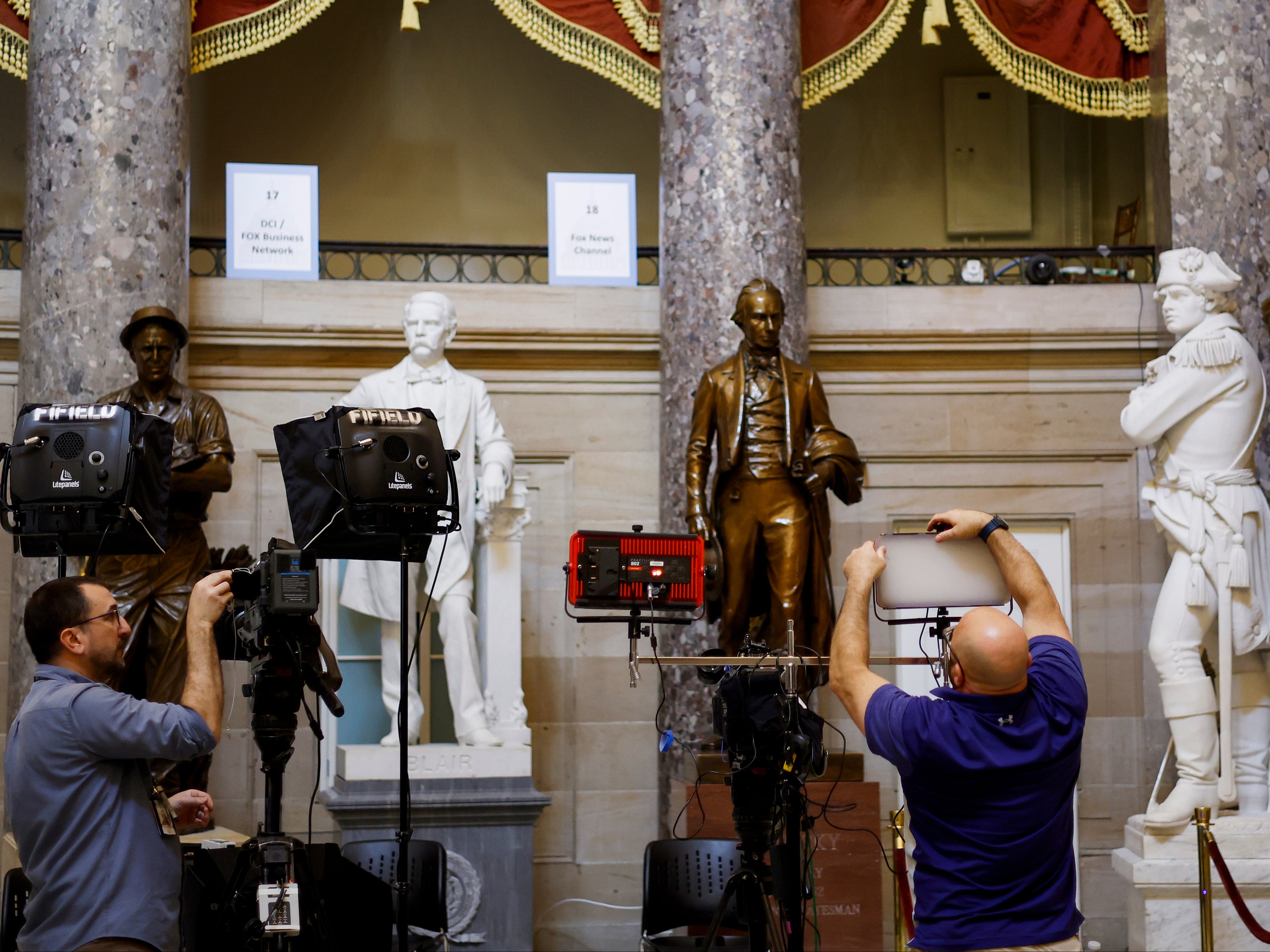 <p>Journalists set up equipment for TV networks in Statuary Hall in the US Capitol on 7 March 2024 in Washington, DC ahead of Joe Biden’s State of the Union speech</p>