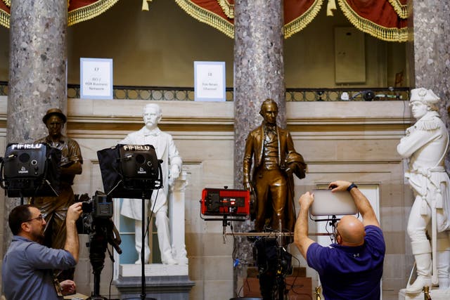 <p>Journalists set up equipment for TV networks in Statuary Hall in the US Capitol on 7 March 2024 in Washington, DC ahead of Joe Biden’s State of the Union speech</p>