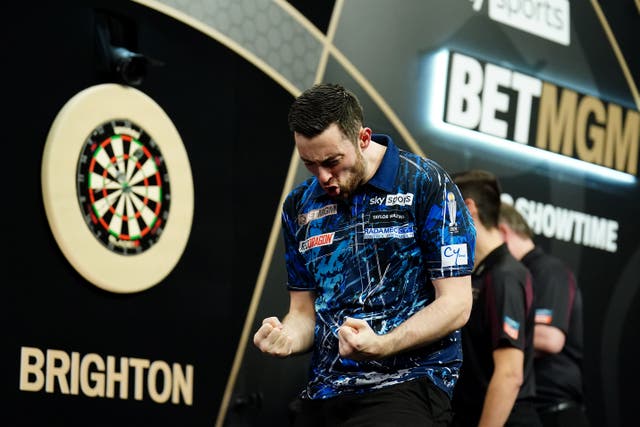 Luke Humphries celebrates after beating Michael Smith in Brighton (Zac Goodwin/PA)