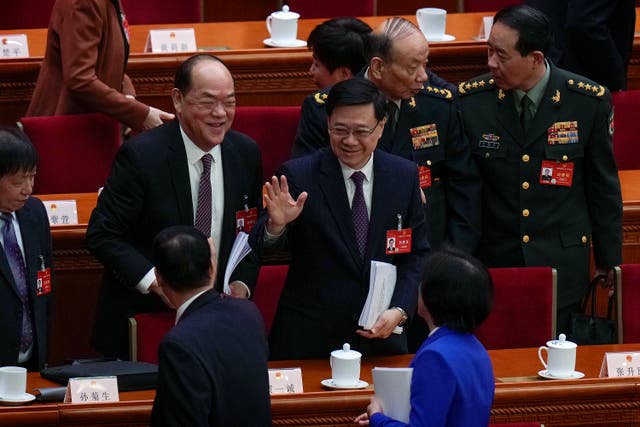 <p>Hong Kong Chief Executive John Lee, center, waves to delegates after the opening session of the National People's Congress </p>