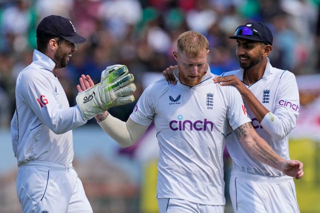 England captain Ben Stokes, centre, celebrates taking the wicket of Rohit Sharma (Ashwini Bhatia/AP)