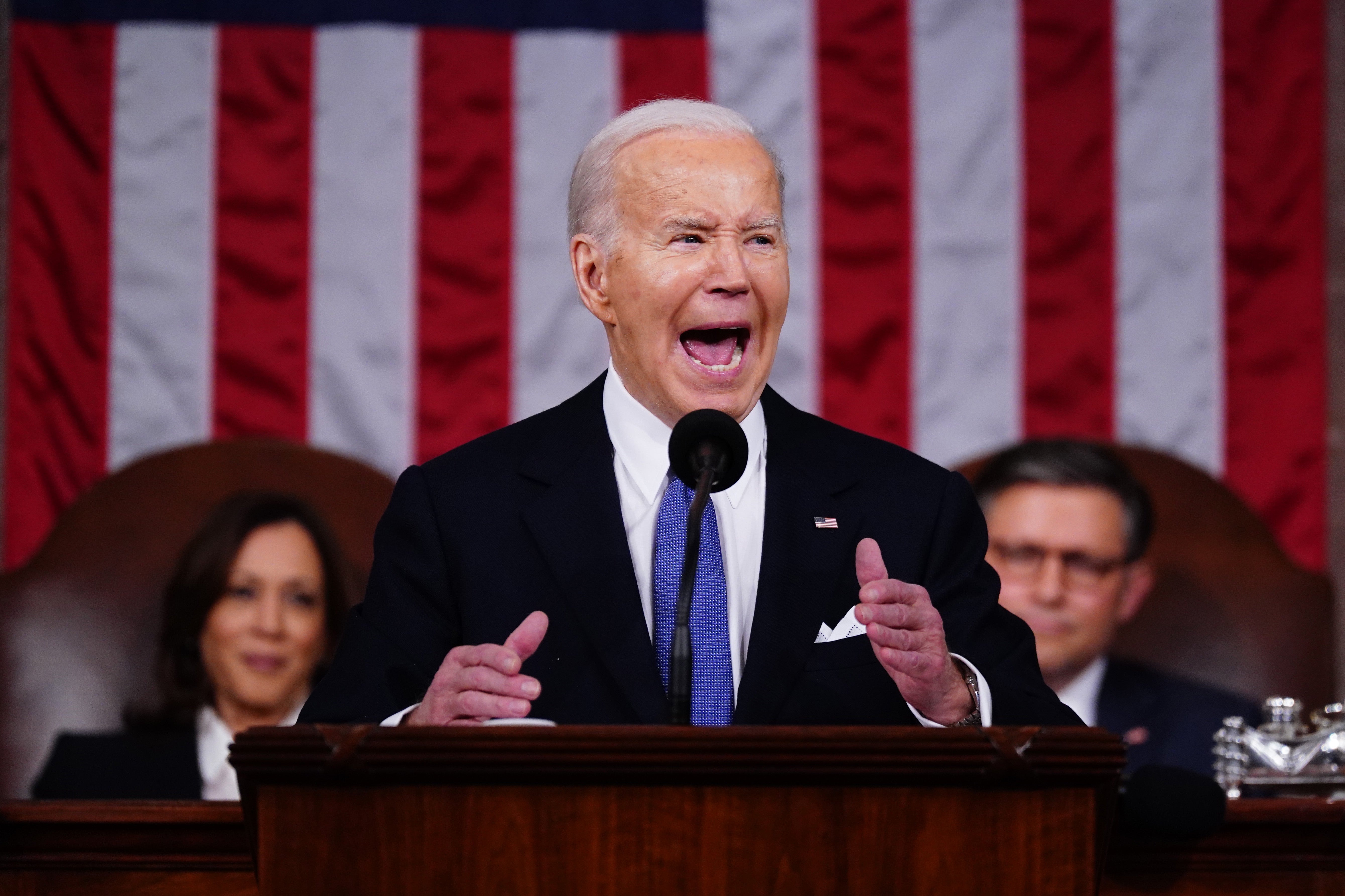US President Joe Biden delivers his third State of the Union address as Vice President Kamala Harris and Speaker of the House Mike Johnson look on