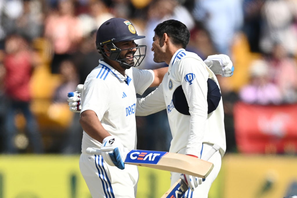 Shubman Gill of India celebrates reaching his century with captain Rohit Sharma