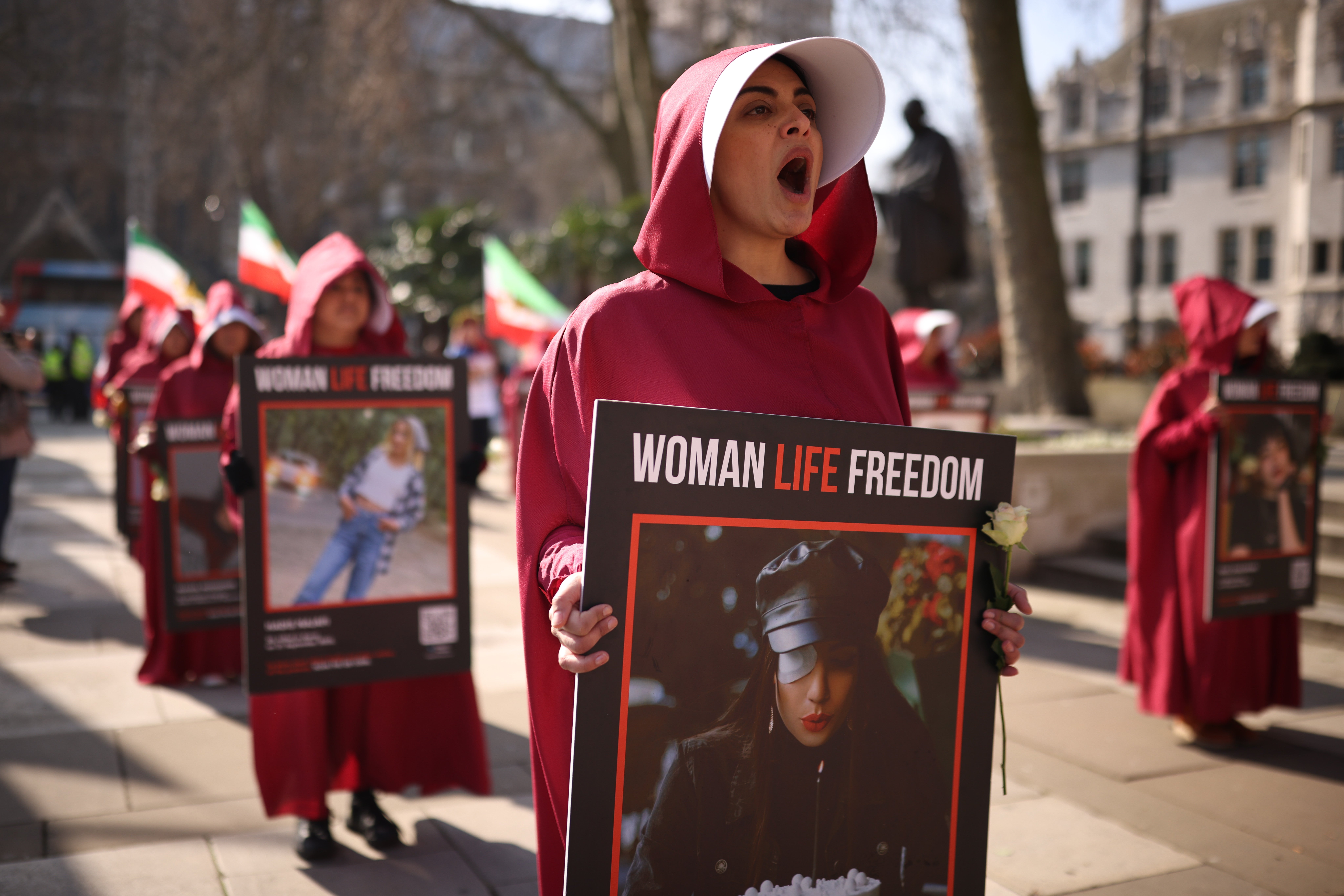 Protesters in London wearing Handmaid robes in 2024