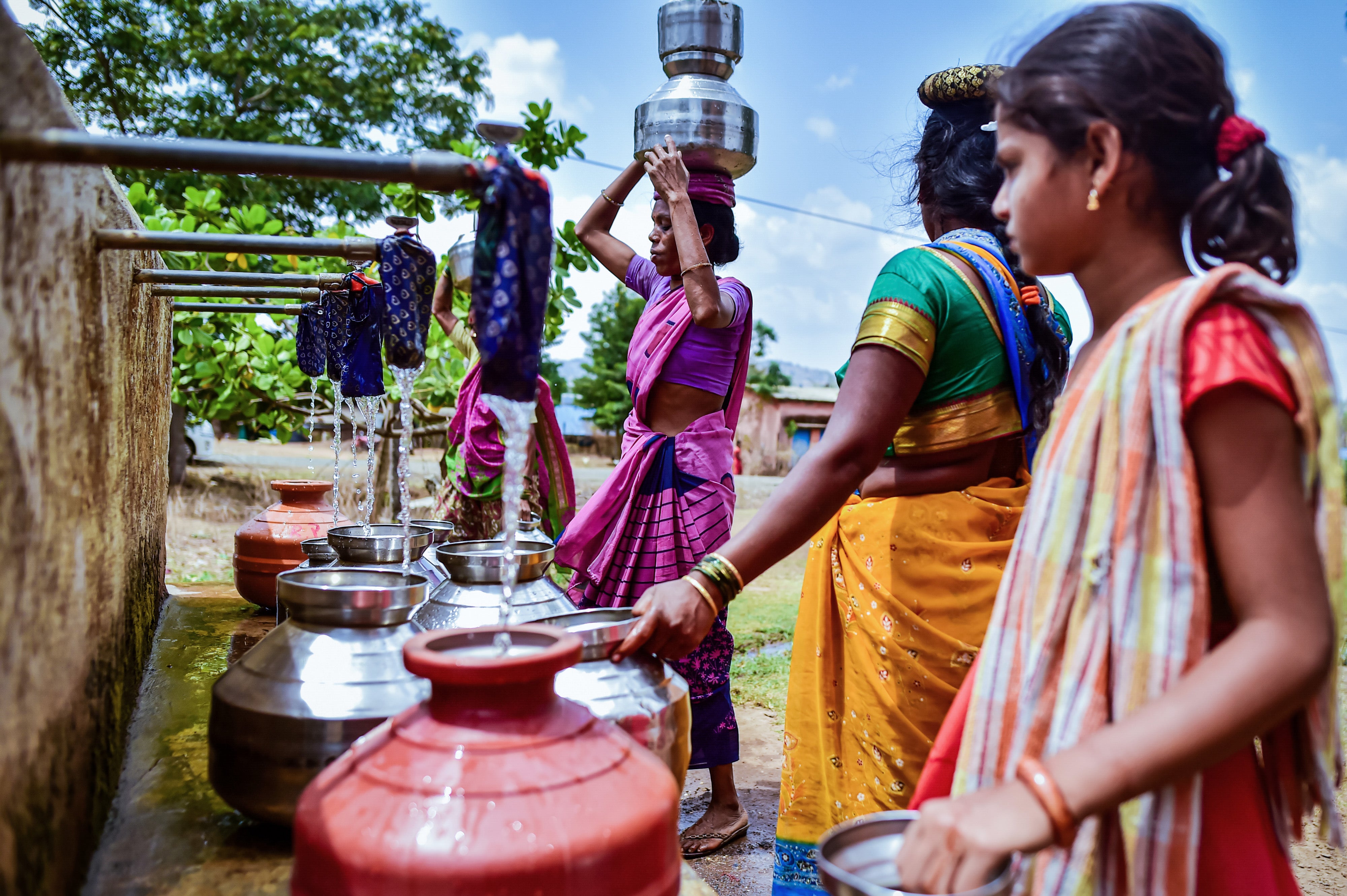 Women fill water from a municipal tank on May 26, 2023 in Peth Taluka village, Nashik, Maharashtra, India.