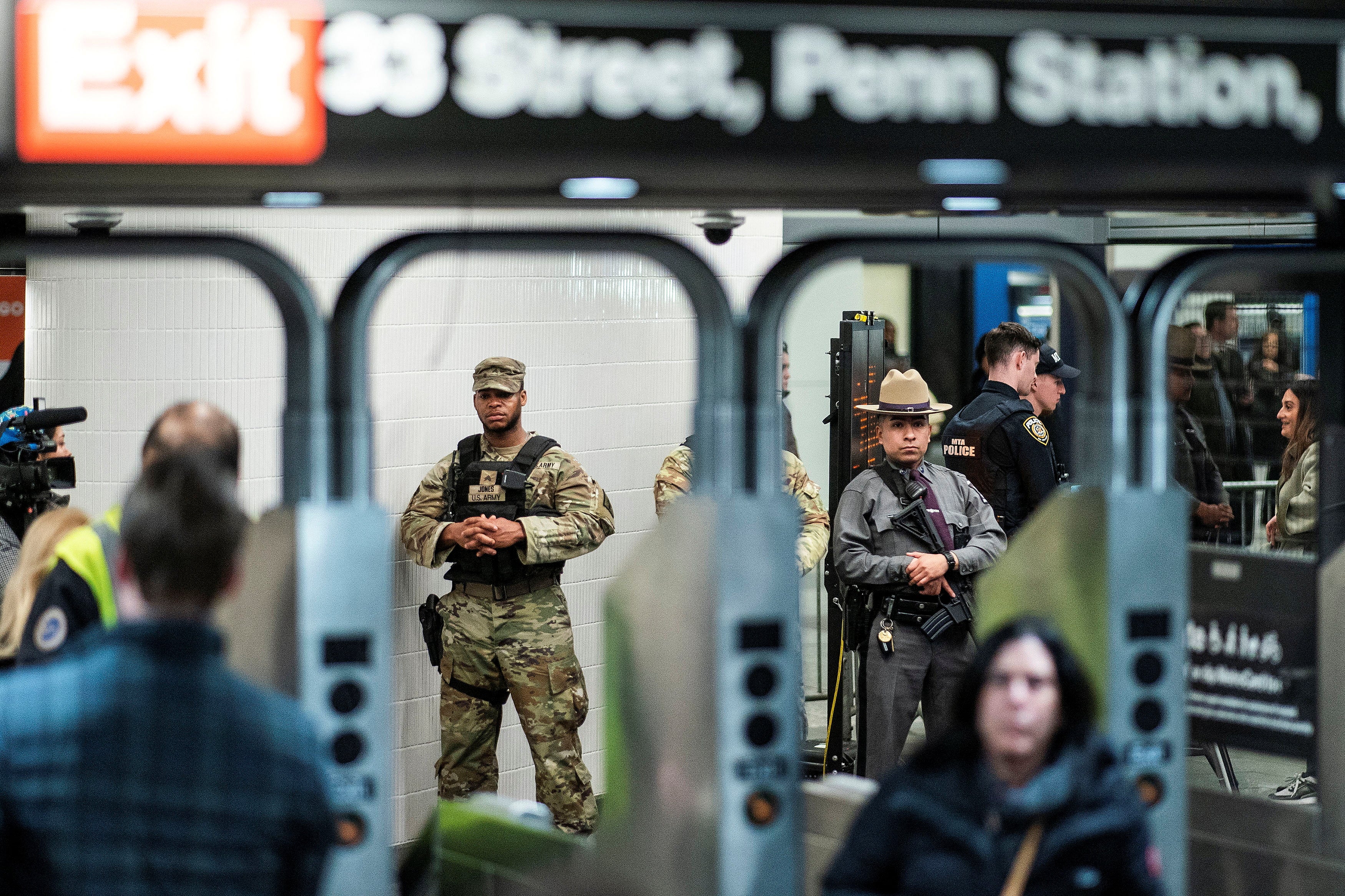 National Guard troops and New York State Police officers patrol Penn Station in New York City on 7 March.