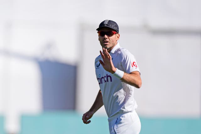 England’s James Anderson gestures to the crowd after taking his 700th wicket (Ashwini Bhatia/AP)