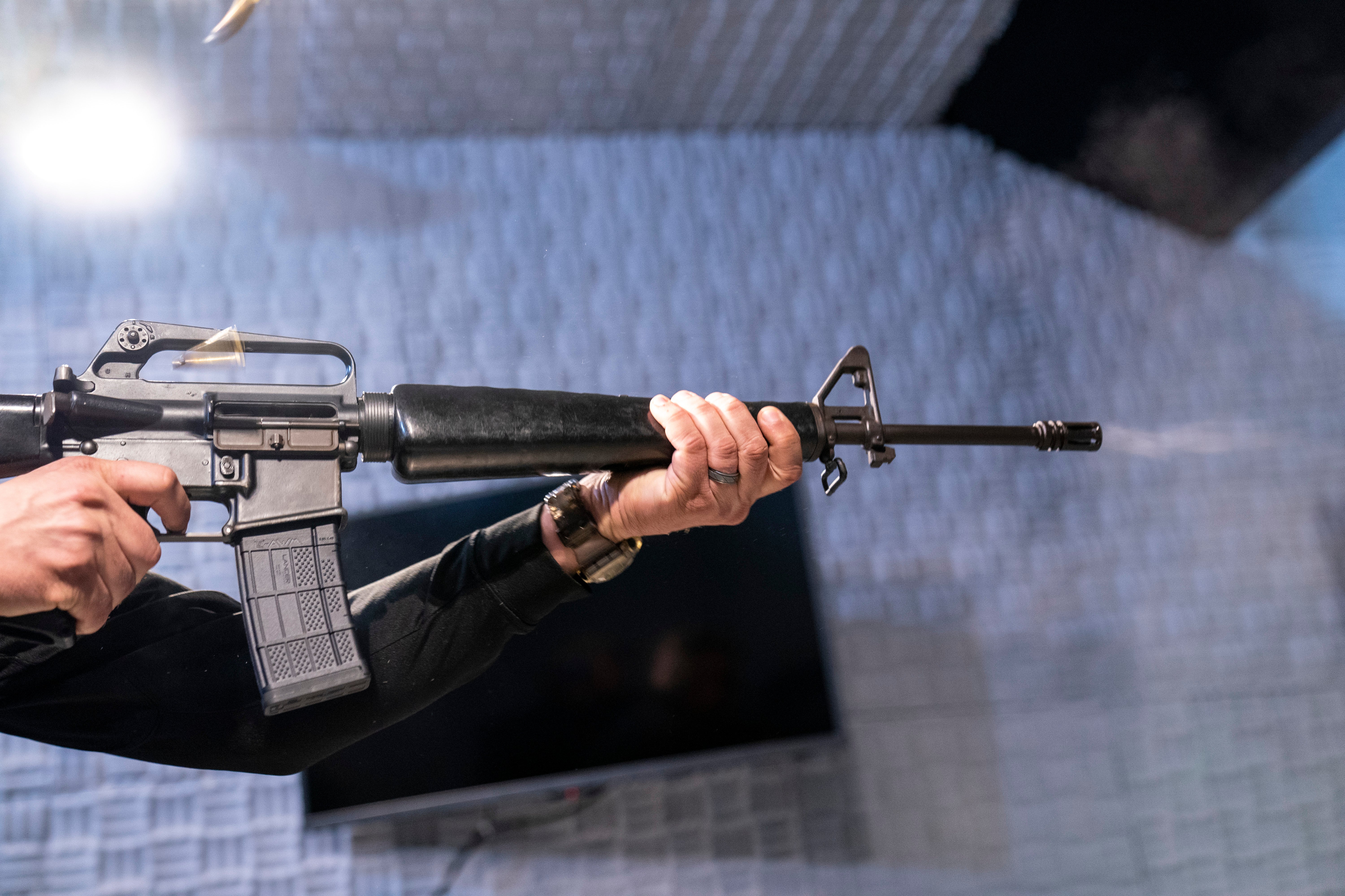 Two empty shell casings fly as a fully automatic M-16 is fired at the Bureau of Alcohol, Tobacco, Firearms, and Explosives