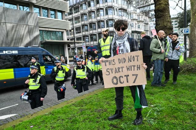 <p>You’d better move on:  police keep a watchful eye over a protester at the National March for Palestine in London last month  </p>
