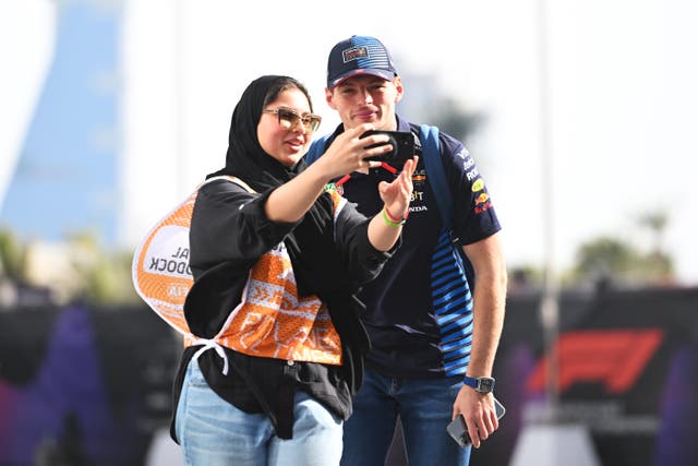 <p>Max Vertsappen poses for a selfie with an F1 fan</p>