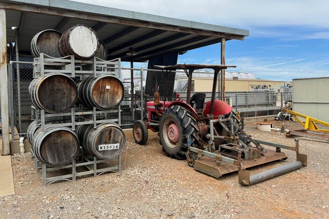 <p>Barrels are stacked next to a tractor parked in the yard of Calabria Wines winery in the town of Griffith in southeast Australia </p>