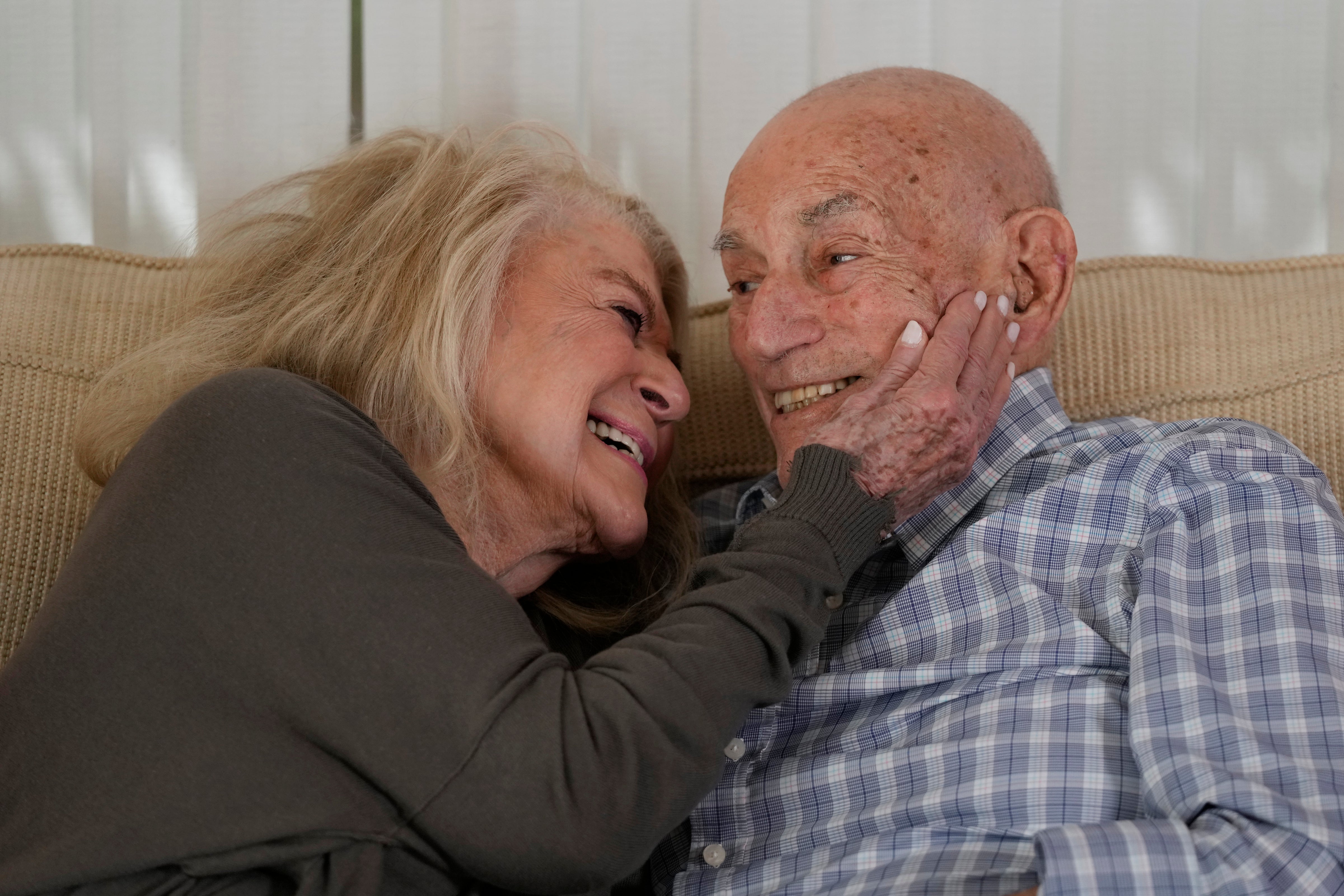 Second World War veteran Harold Terens, 100, right, and Jeanne Swerlin, 96, hug during an interview on February 29