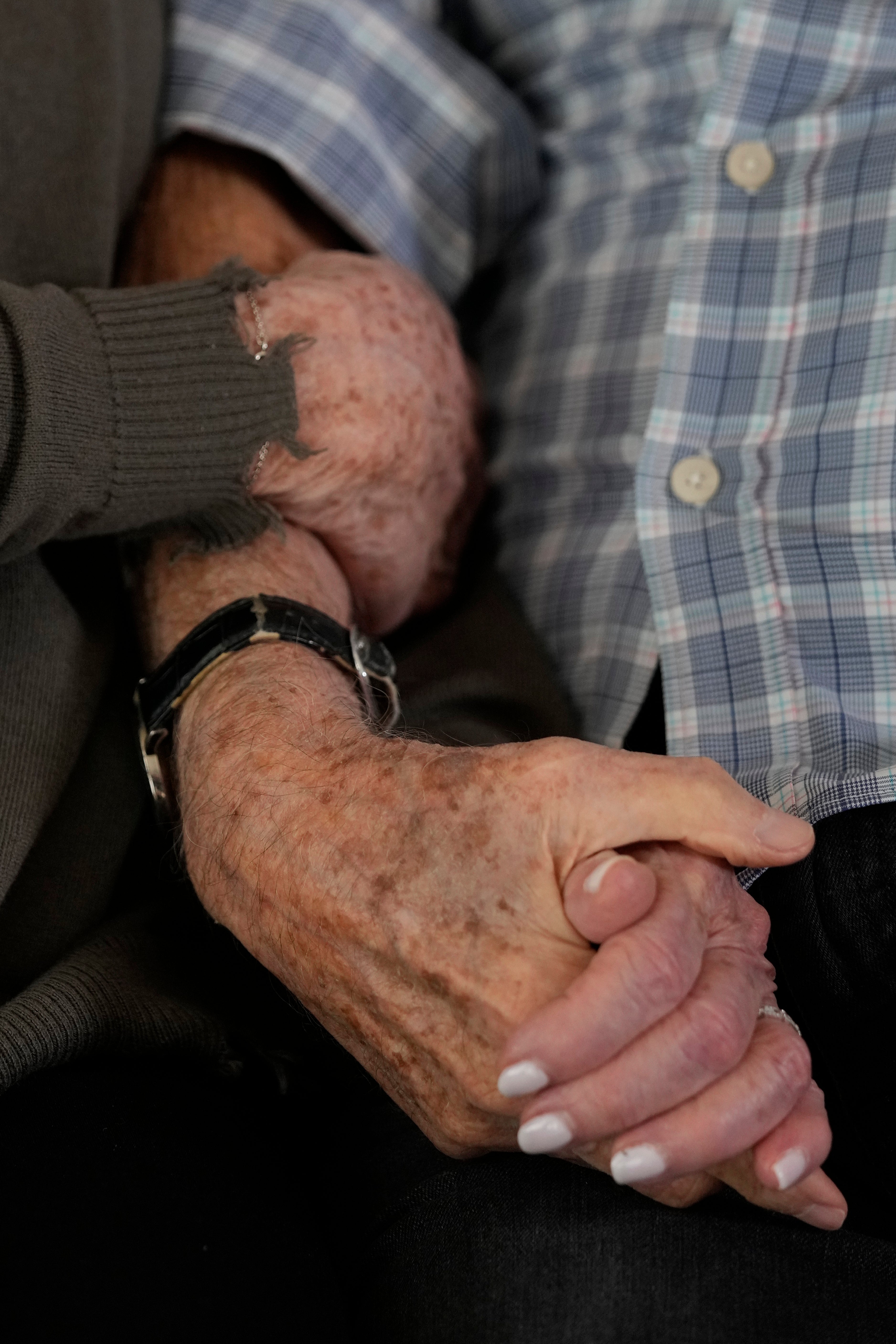 Second World War veteran Harold Terens, 100, right, holds hands with Jeanne Swerlin, 96, as they speak during an interview