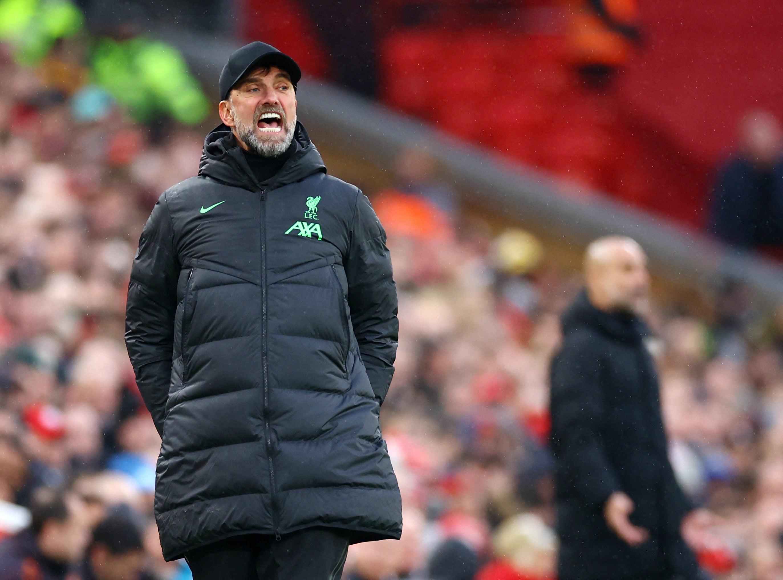 Klopp and Guardiola during the match at Anfield