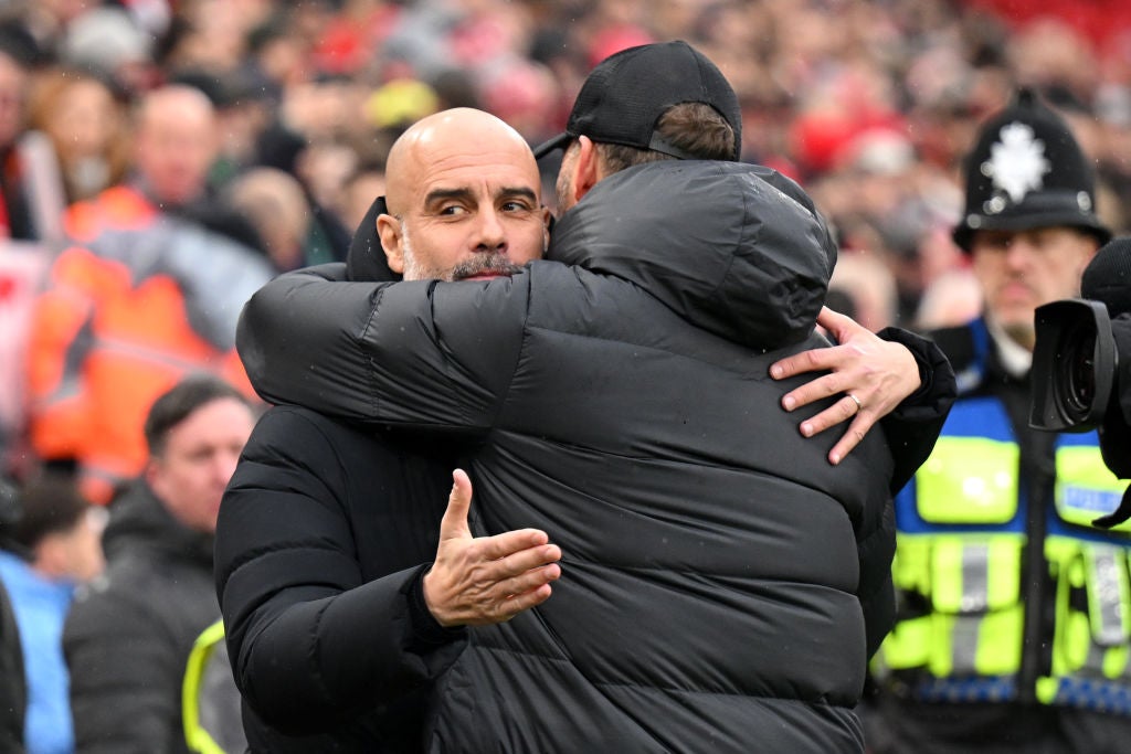 Klopp and Guardiola hug on the touchline at Anfield