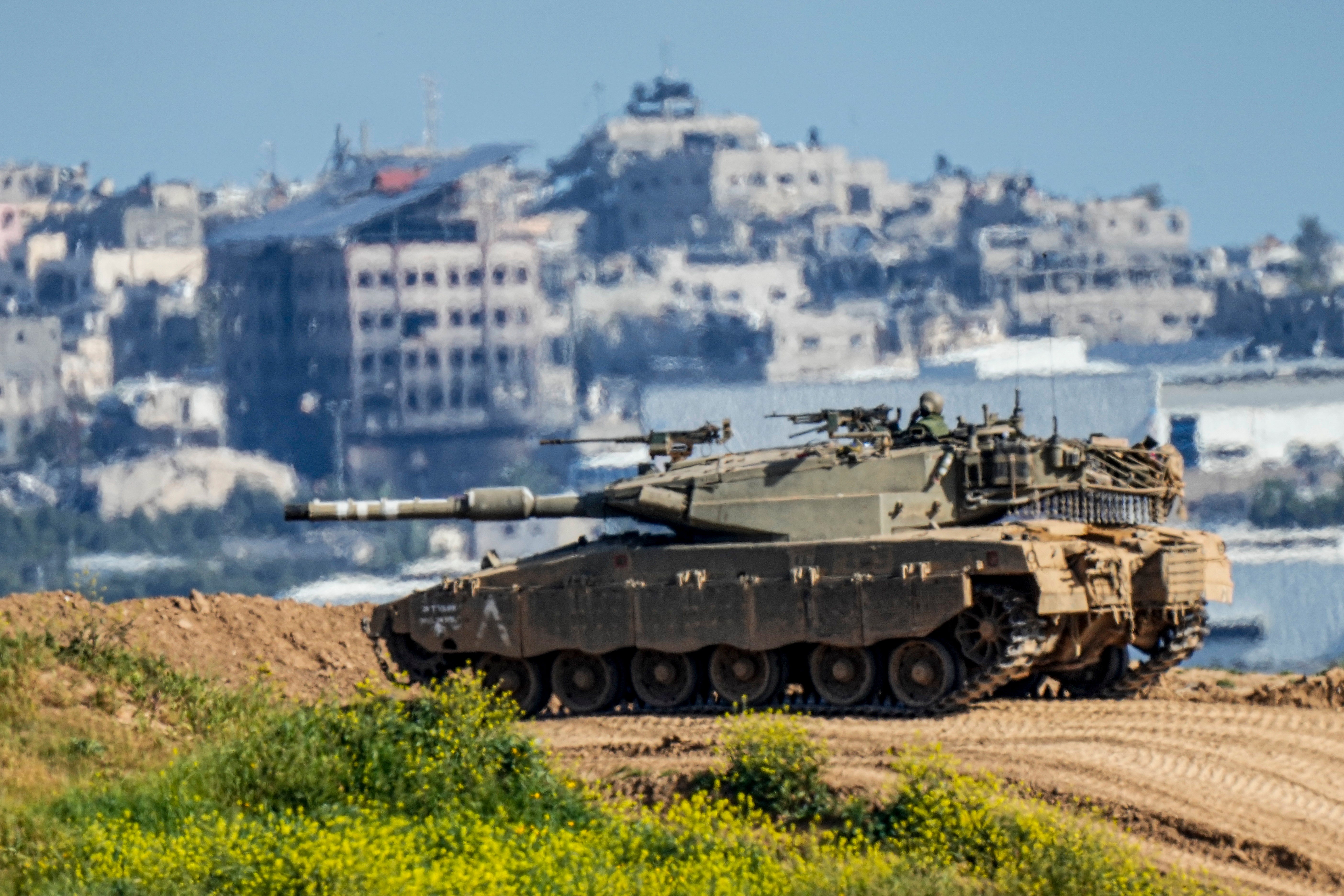 An Israeli soldier on top a tank on the border with the Gaza Strip, in southern Israel, Sunday, March 10, 2024