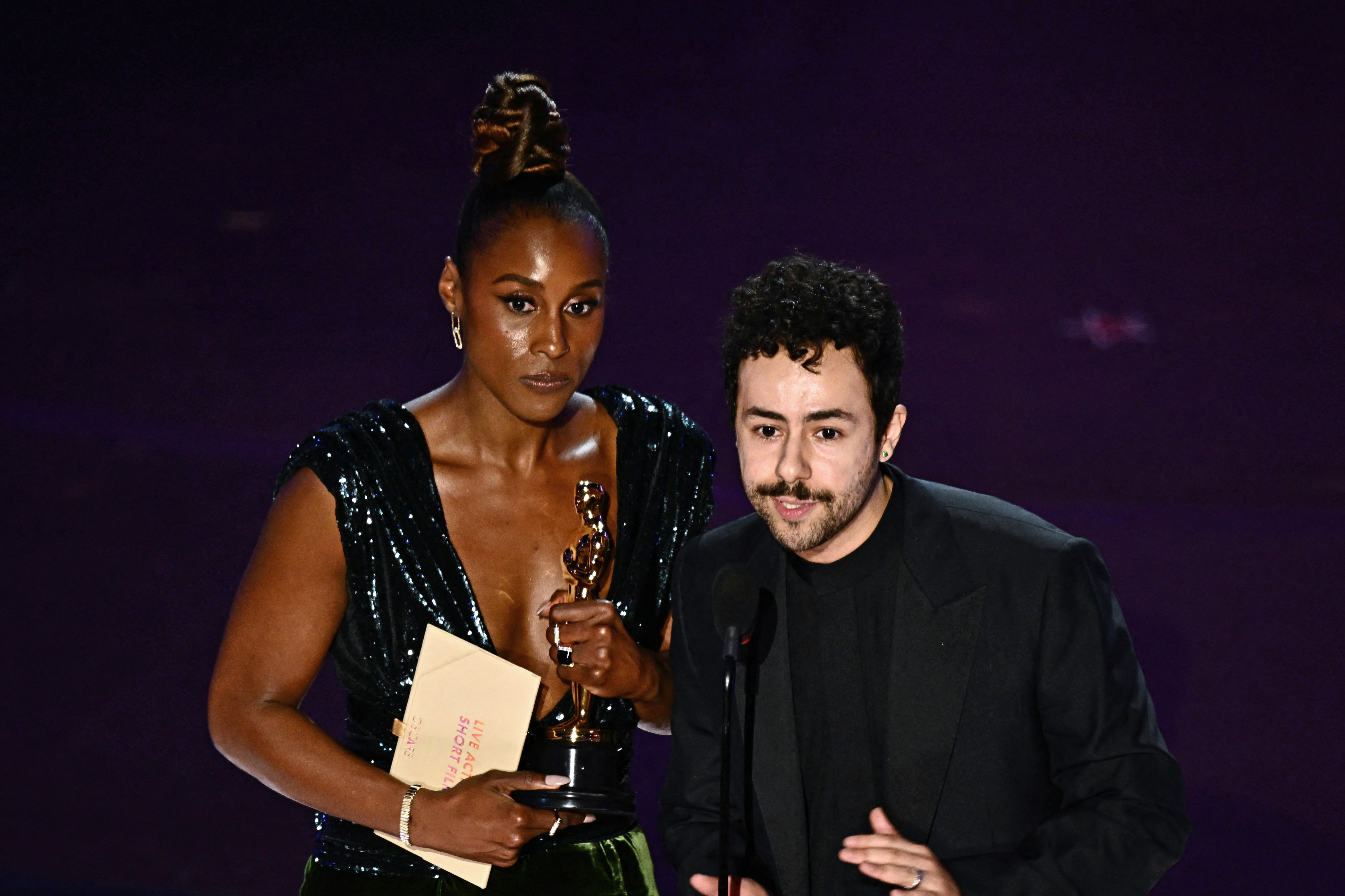 Issa Rae and US comedian Ramy Youssef accept the award for Best Live Action Short Film on behalf of Anderson