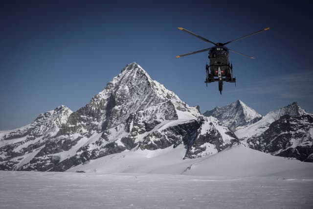 <p>A helicopter heads towards the Matterhorn </p>