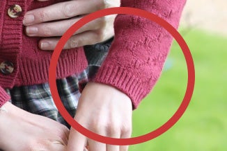 Concerns have been raised over the sleeve of Princess Charlotte’s cardigan, which does not appear to line up in the photo