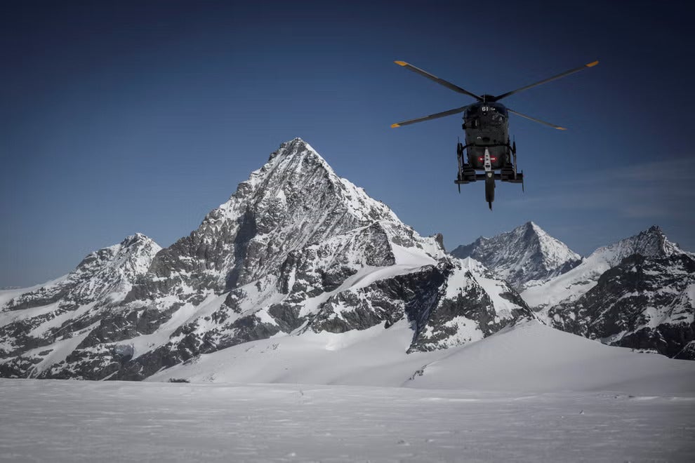 A helicopter heads towards the Matterhorn