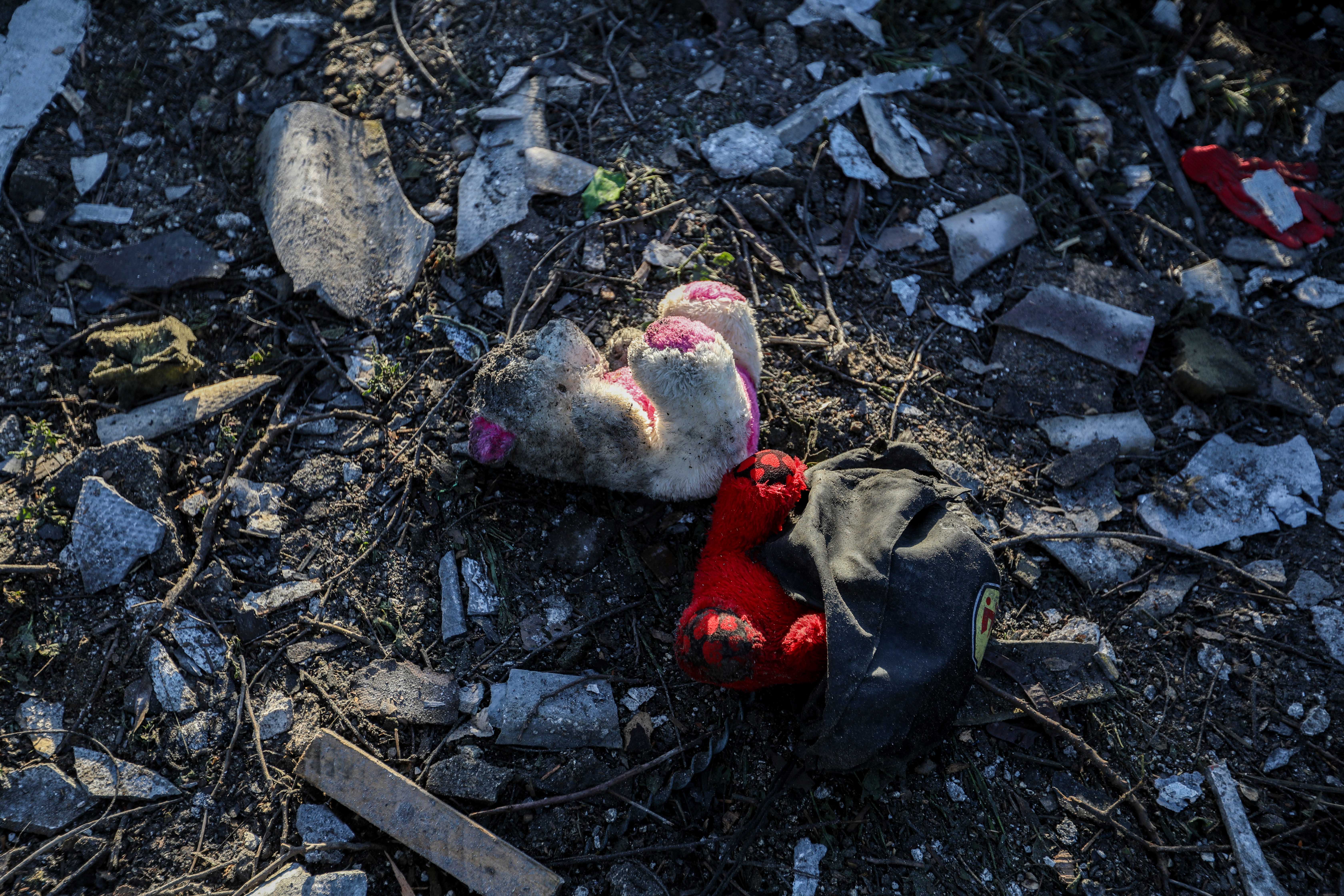 <p>File: Palestinians recover belongings from destroyed homes following Israeli air strikes on 11 March in Rafah, Gaza</p>