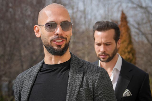 Andrew Tate, left, and his brother Tristan arrive at the Bucharest Tribunal in Romania last month (Vadim Ghirda/AP)