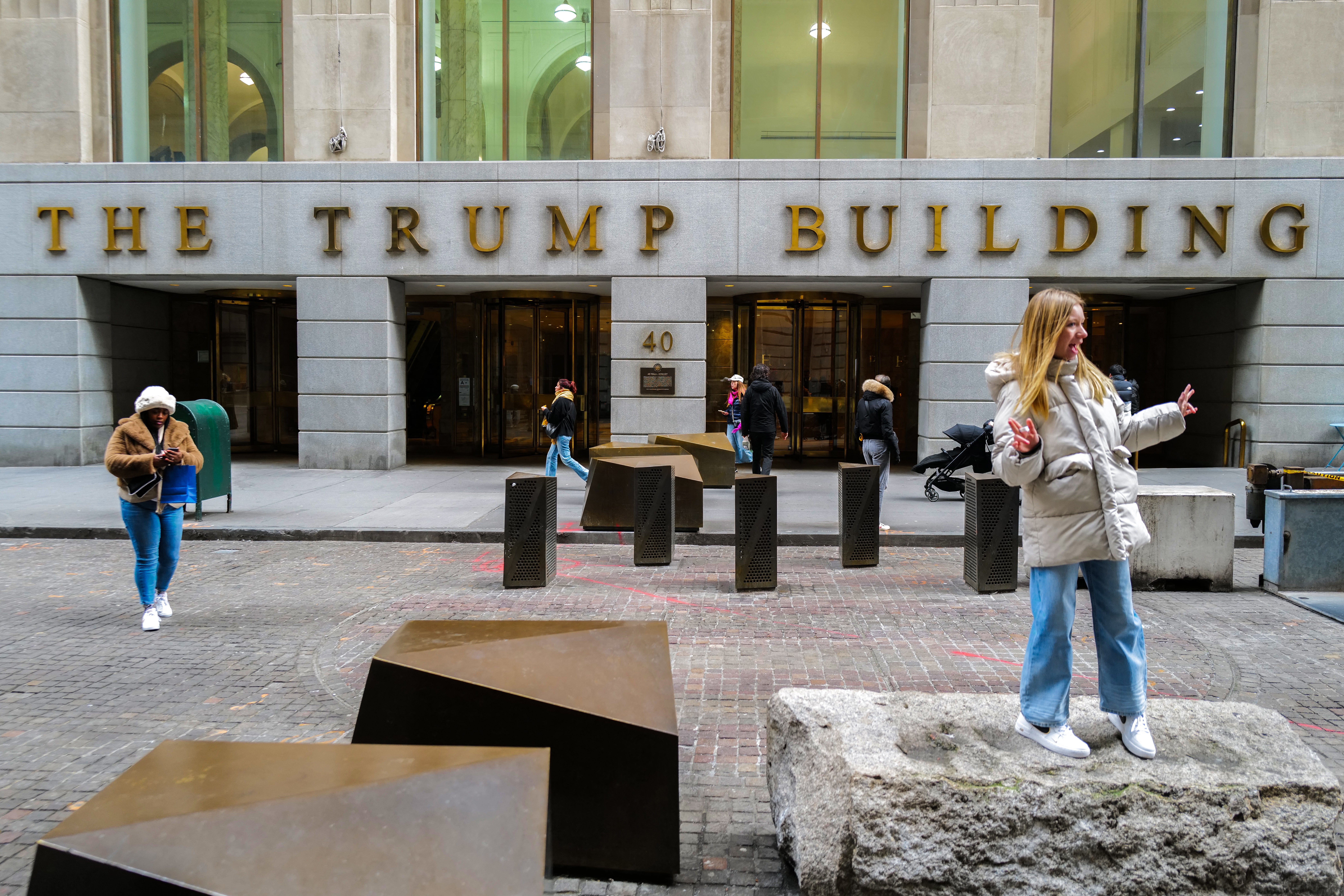 People stand outside of 40 Wall Street, also known as ‘the Trump Building’, on 12 February 2024 in New York City