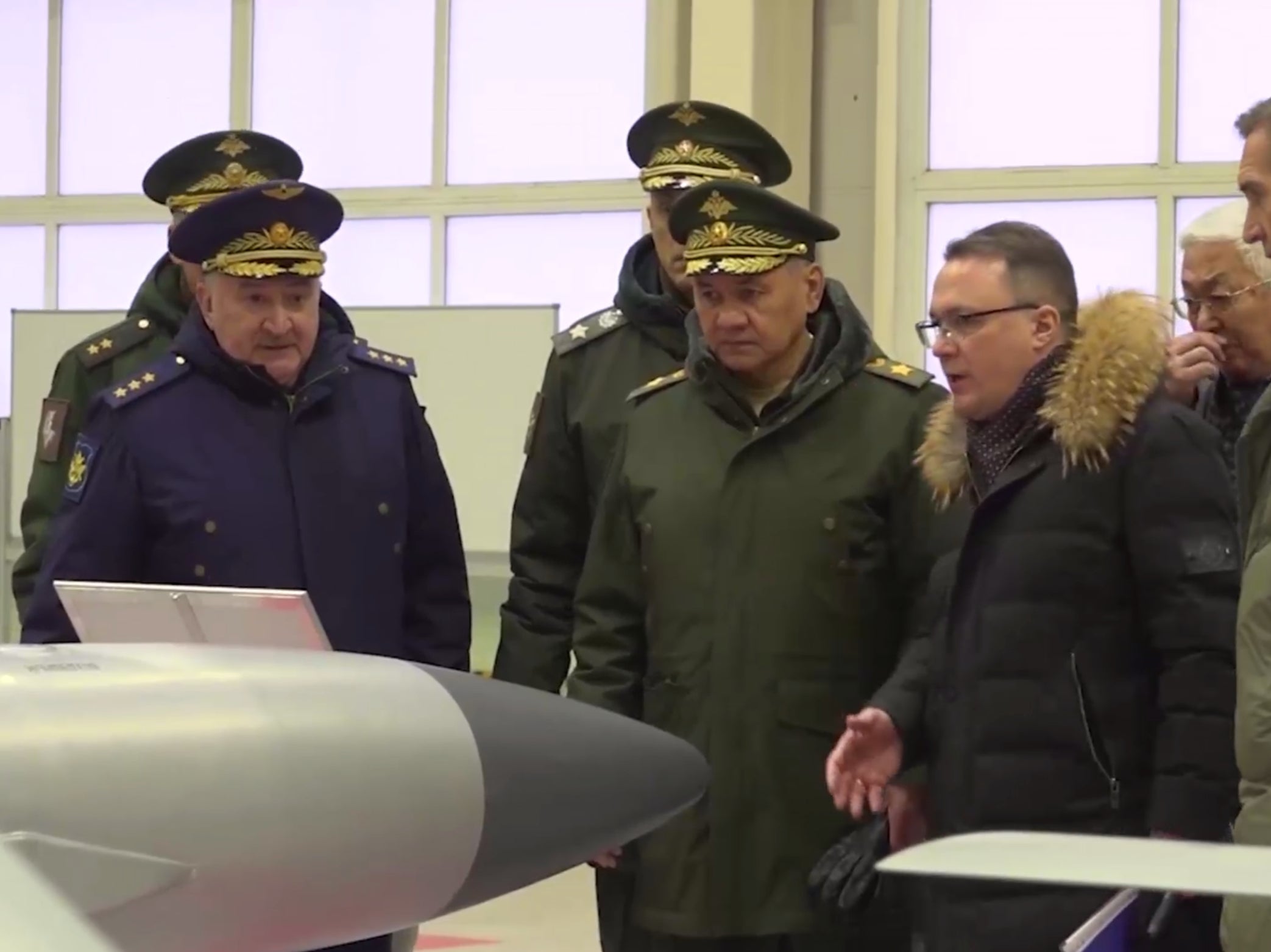 Sergei Shoigu (centre) visits a Russian weapons factory in the Moscow region in January suspected of building modified FAB bombs