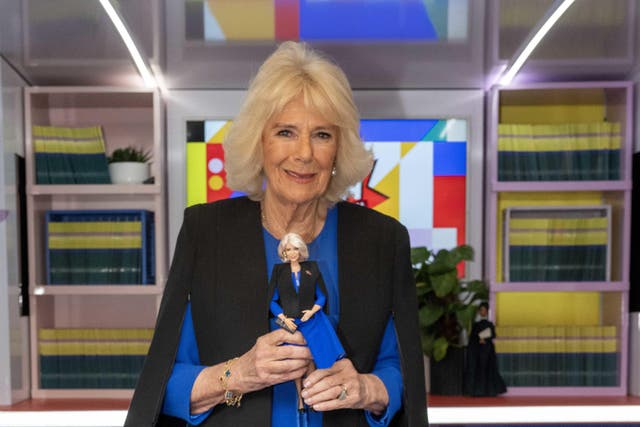 Queen Camilla, President of Women of the World (WOW), is presented with a Barbie doll, dressed in her outfit, in recognition of her work supporting WoW during a reception to celebrate International Women’s Day and mark the end of the WOW Girls Festival Bus tour, at Buckingham Palace, London. Picture date: Tuesday March 12, 2024.