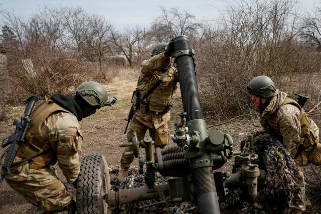 <p>Service members with the Freedom of Russia Legion under the Ukrainian Army prepare to fire a mortar at a Russian military position</p>