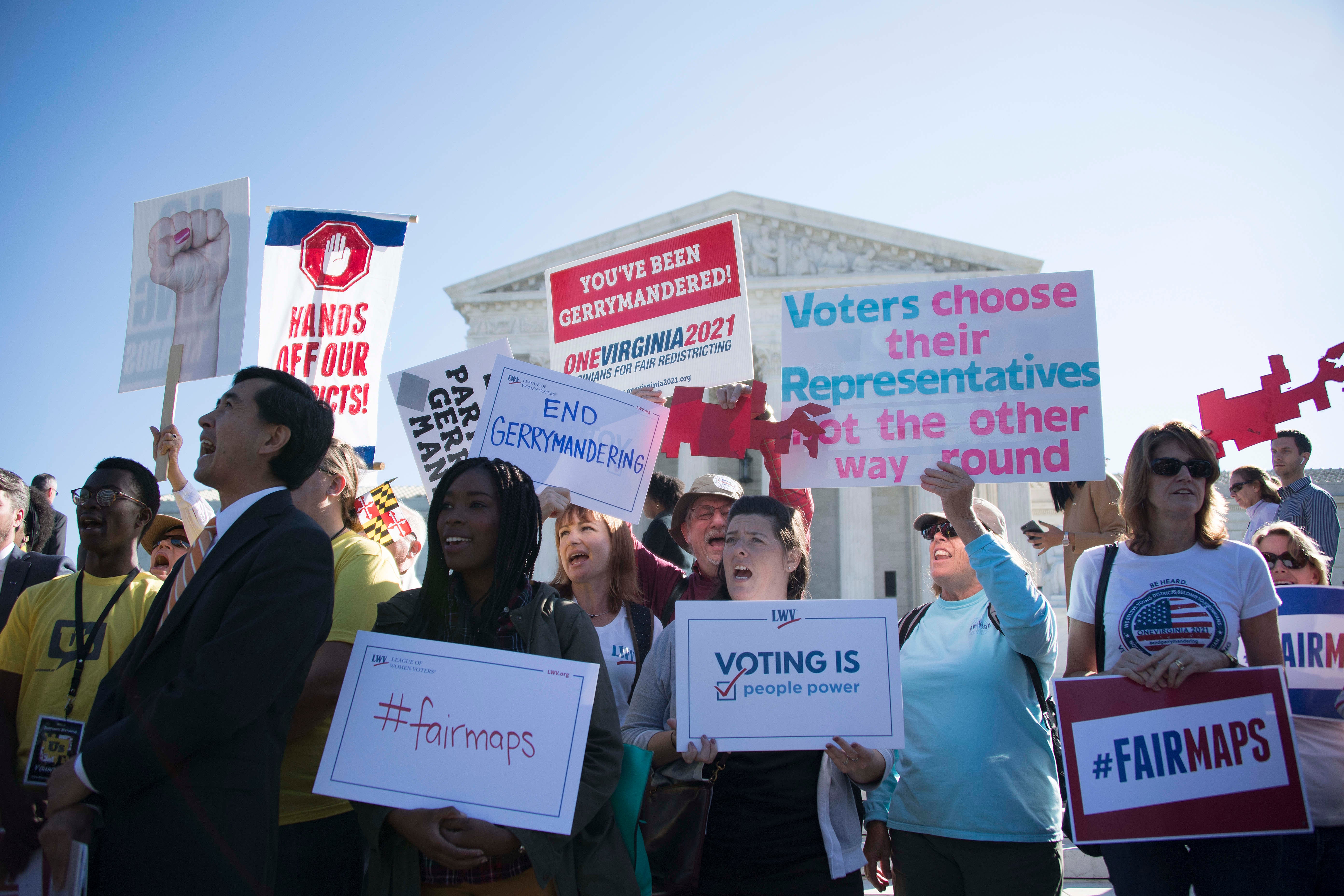 Demonstrators protest outside the US Supreme Court in Washington, DC, October 3, 2017, as the court hears arguments against gerrymandering