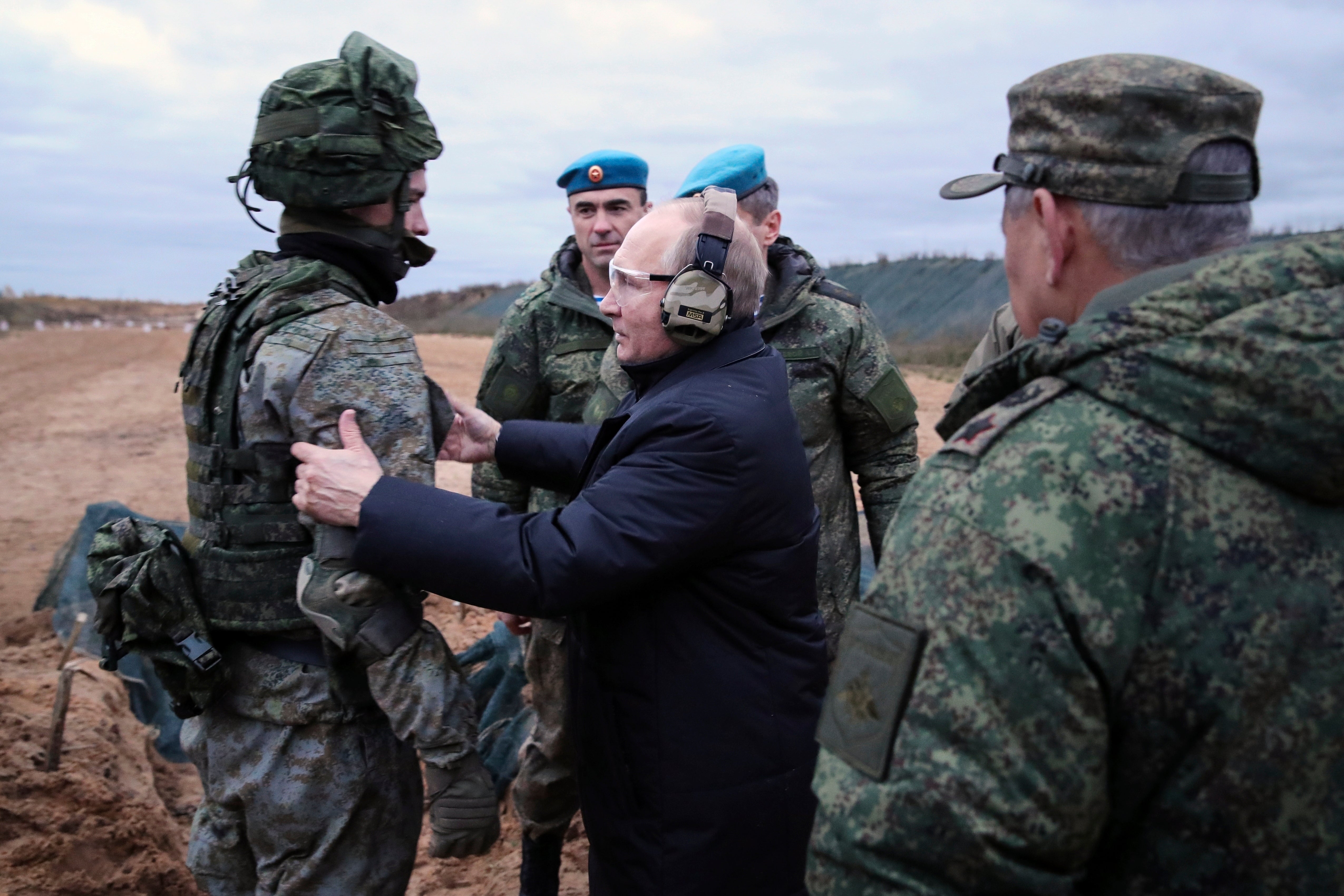 The perennial president speaks to a soldier while visiting a military training centre in 2022